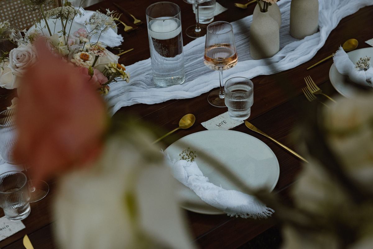 Reception tablescape seen through soft focus flowers