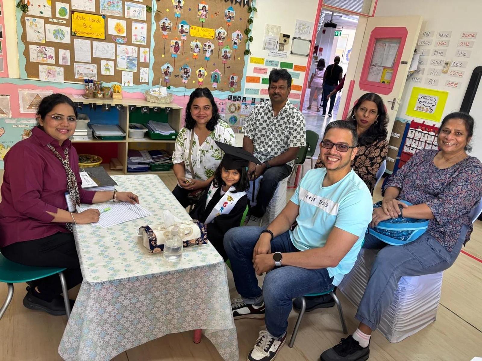 Families and an educator meeting in a nursery classroom