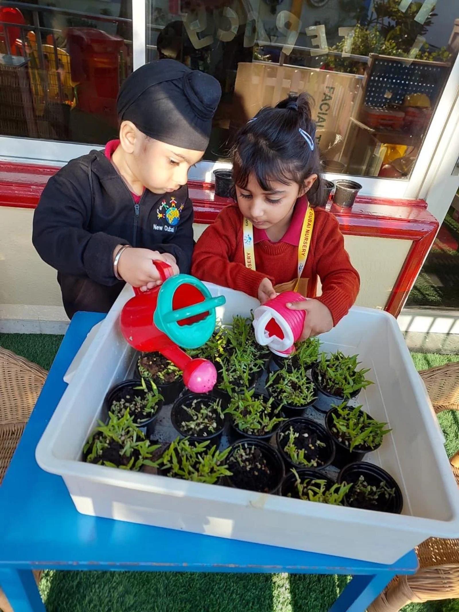 Children watering plants together