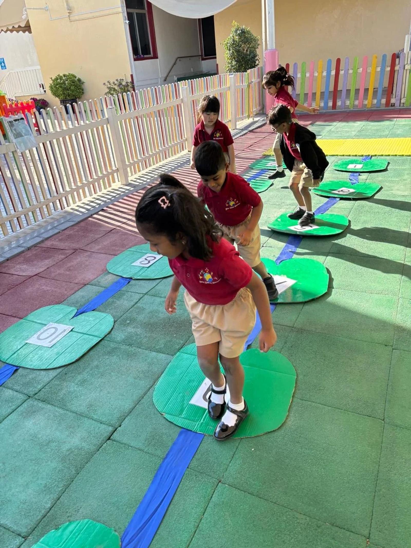 Children balancing along a line of stepping stones