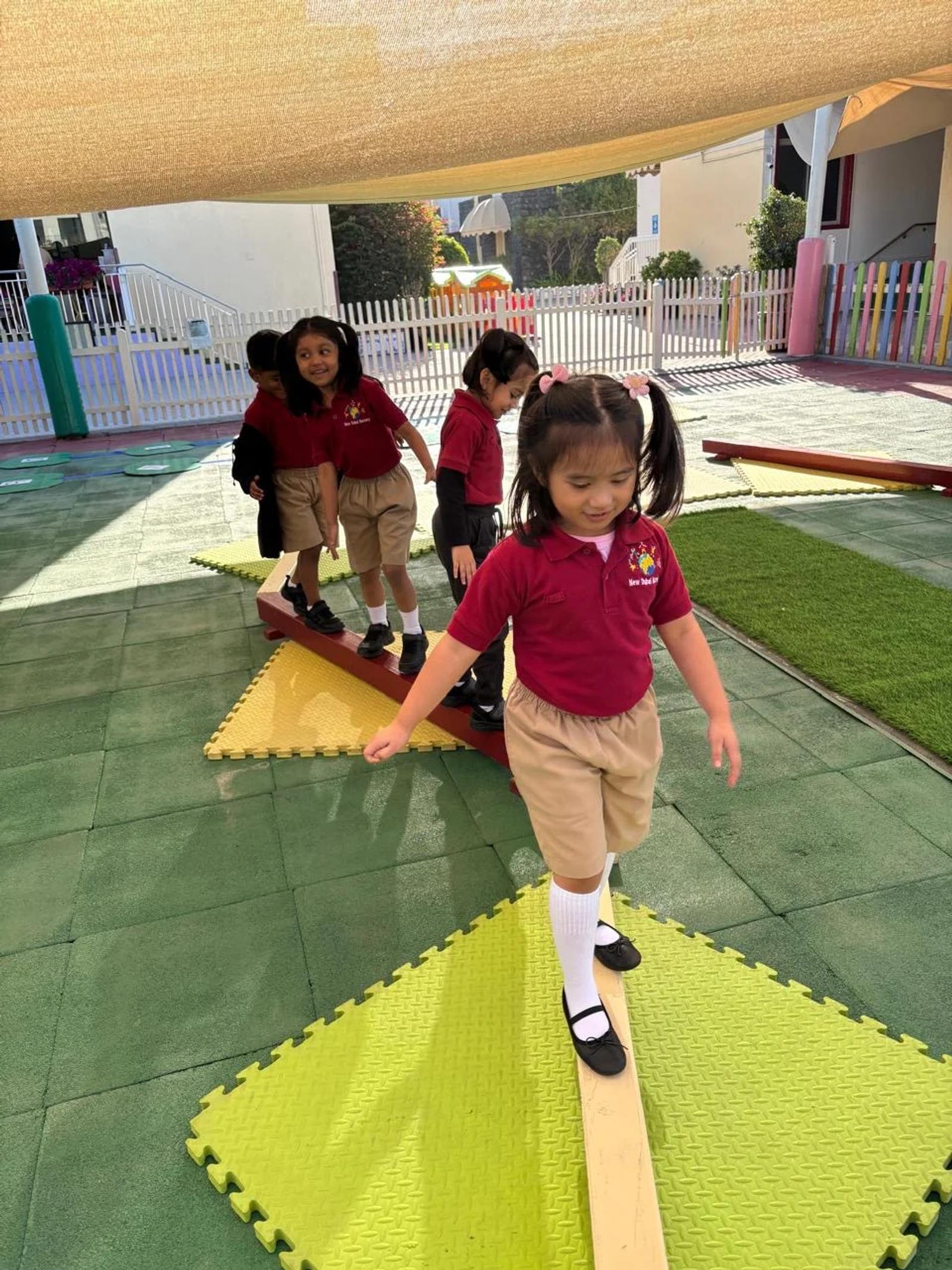 Children practising balance along an outdoor activity path