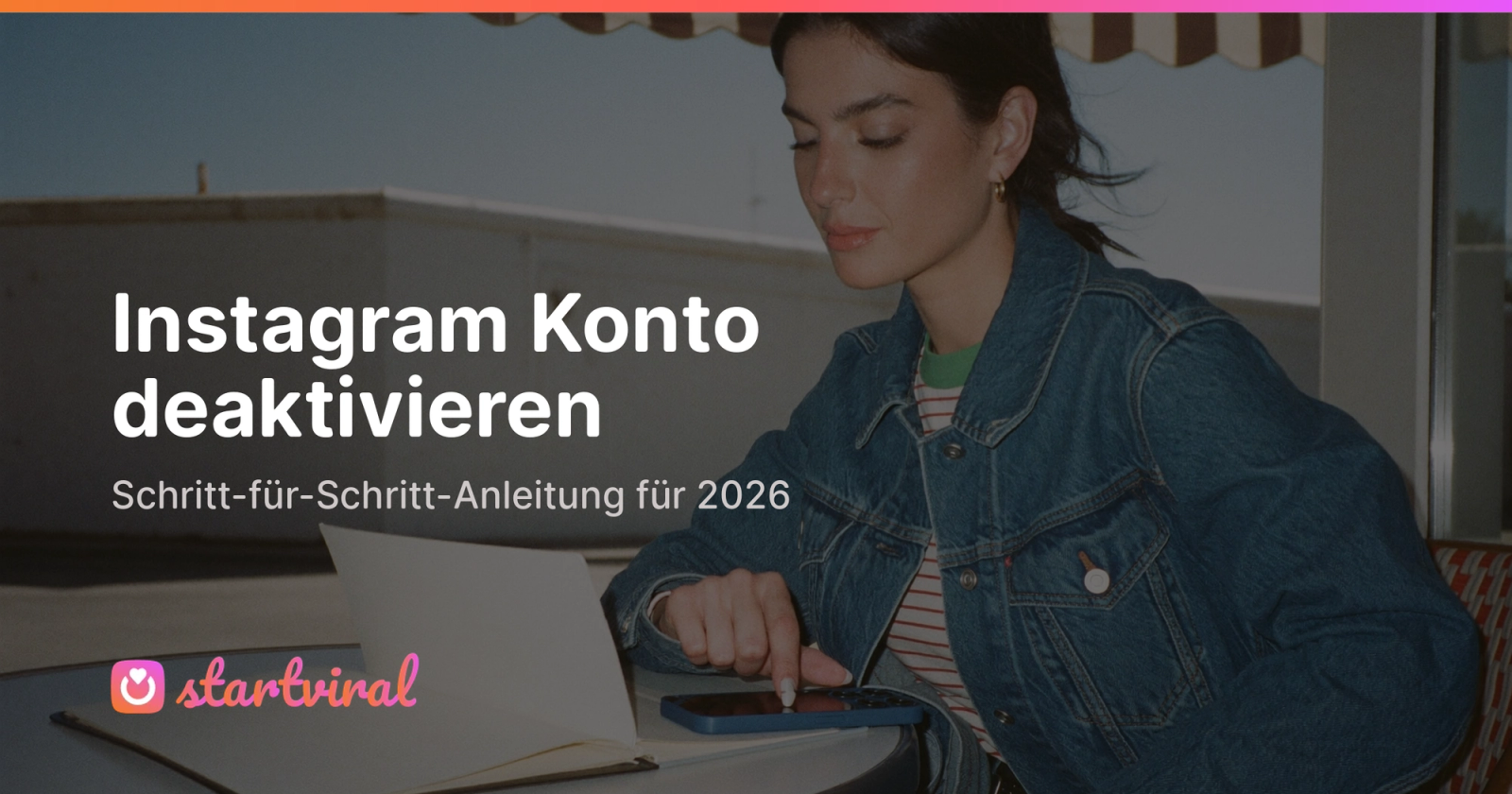 Frau sitzt an einem Cafetisch am sonnigen Straßeneck und blickt ruhig auf ihr Handy.