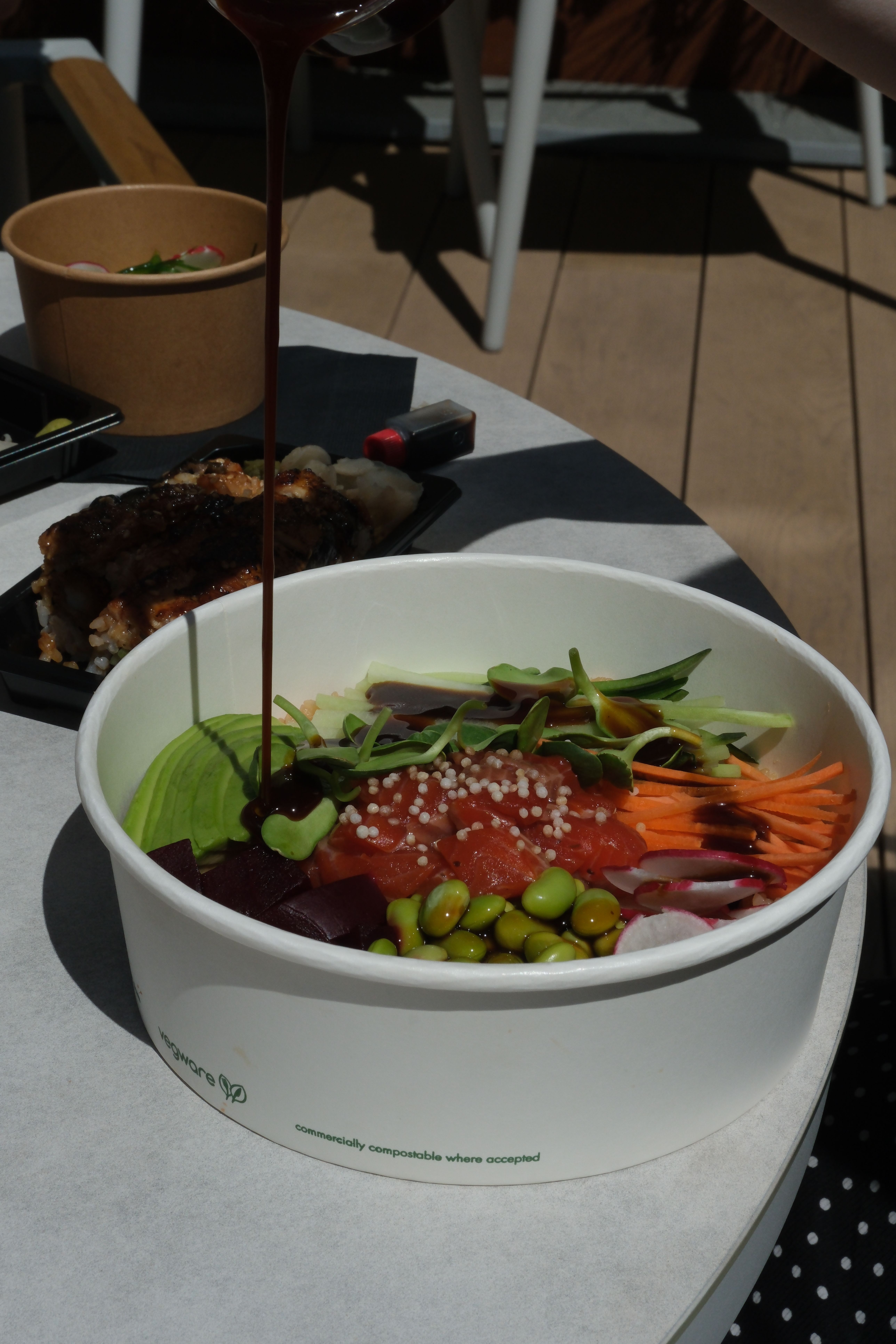 poke bowl with raw fish, rice, edamame, carrot, cabbage