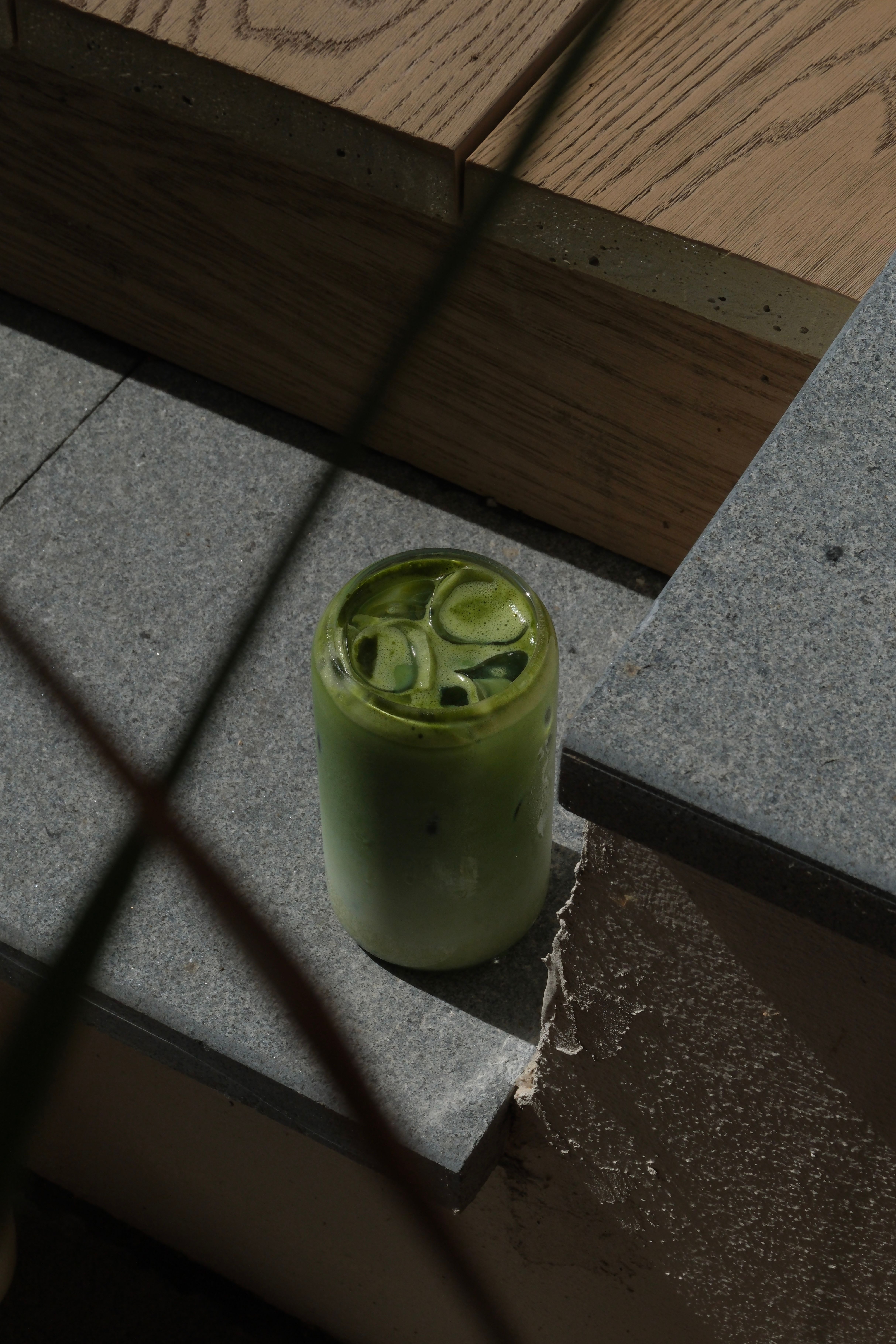 An iced green matcha latte in a tall glass