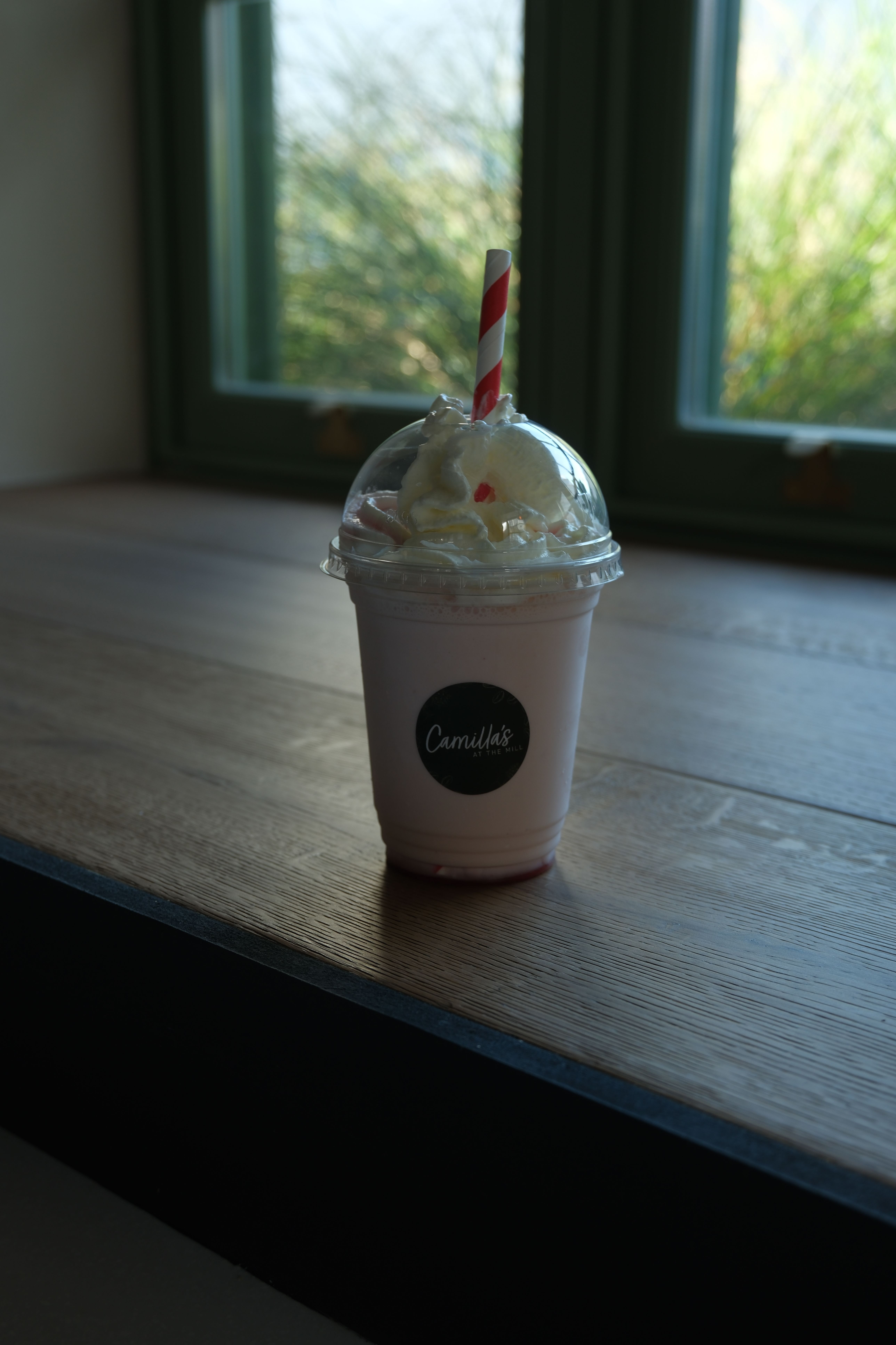 A strawberry milkshake topped with cream