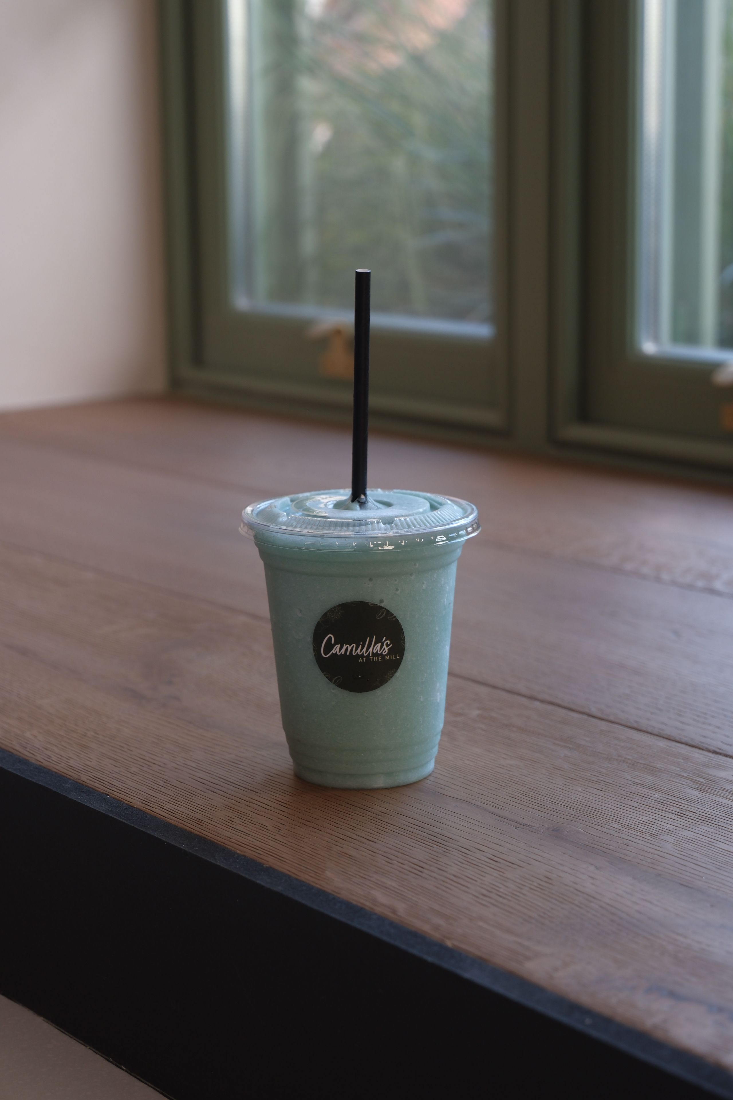 A blue spirulina smoothie in a glass