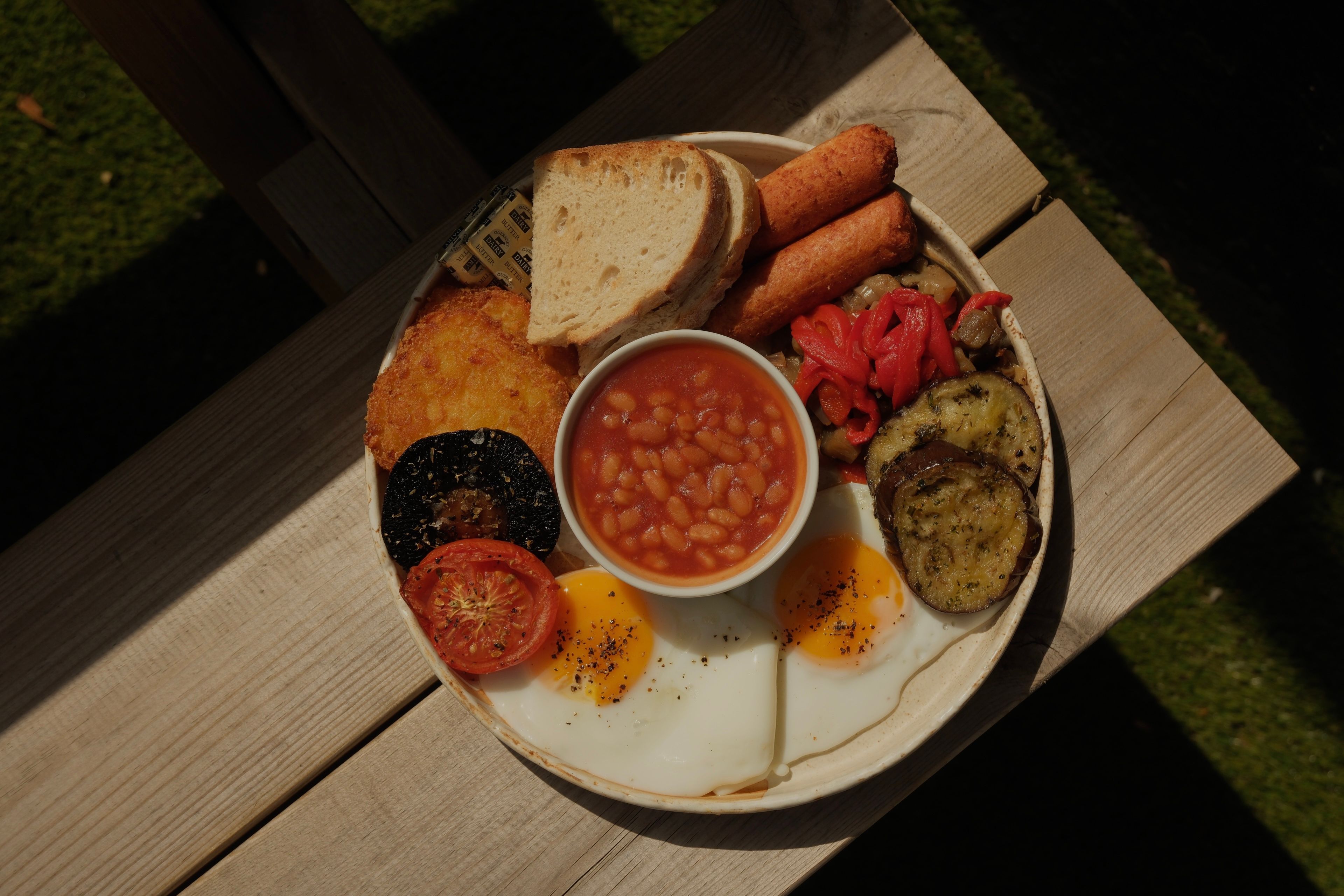 A vegetarian cooked breakfast with cheese sausages, eggs, beans and toast