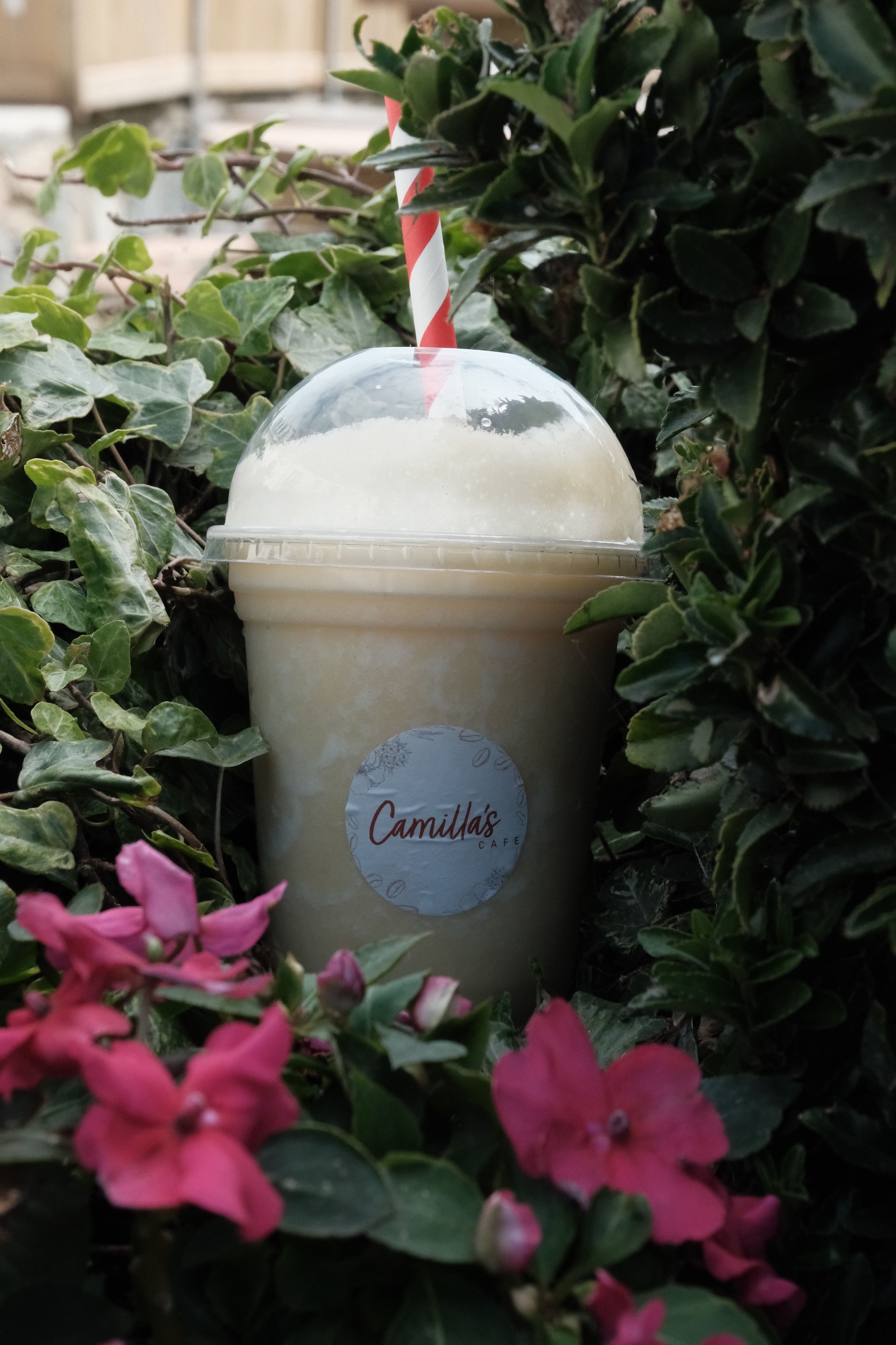 A coconut and pineapple smoothie in a glass