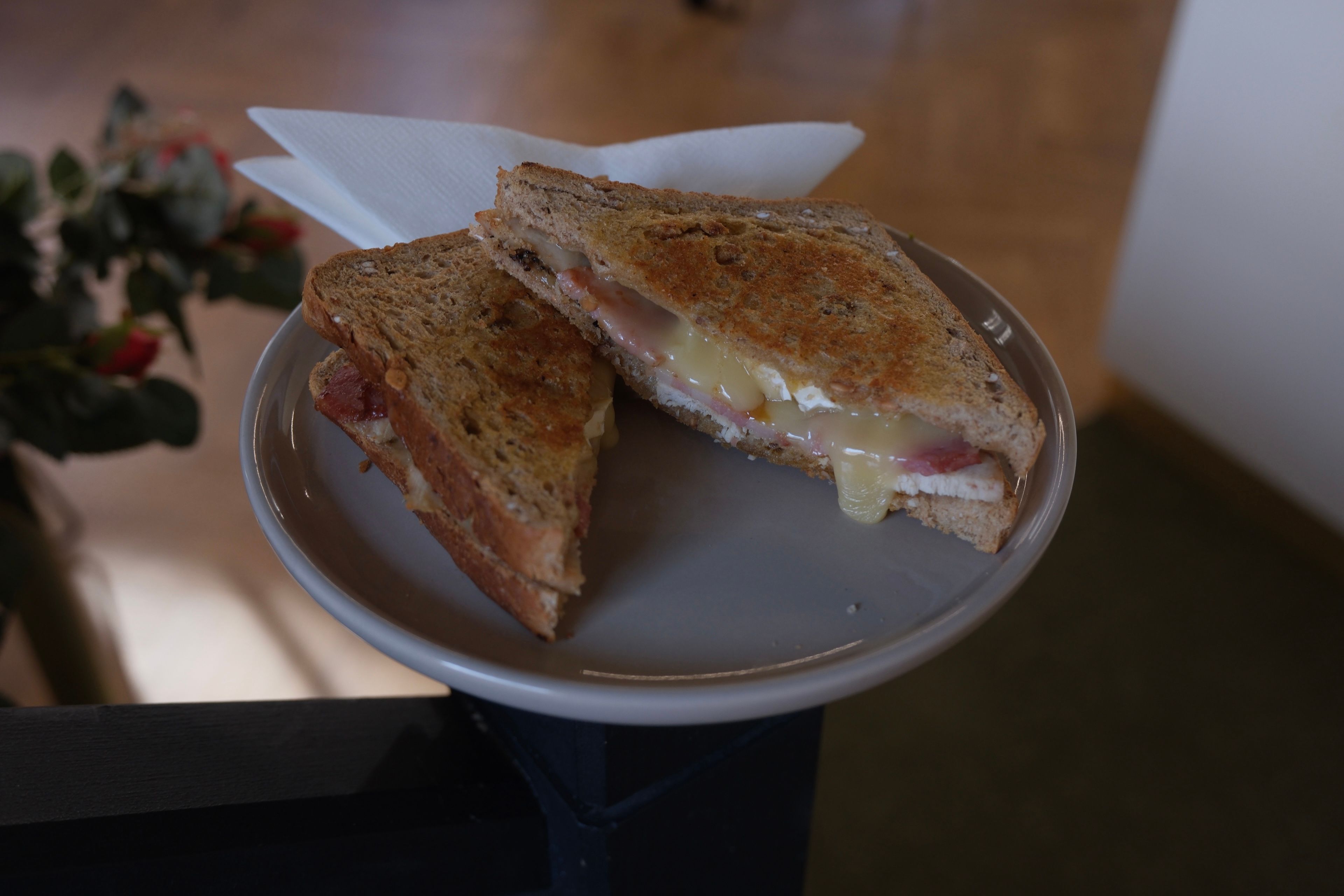A toasted chicken, bacon, chorizo and brie sandwich