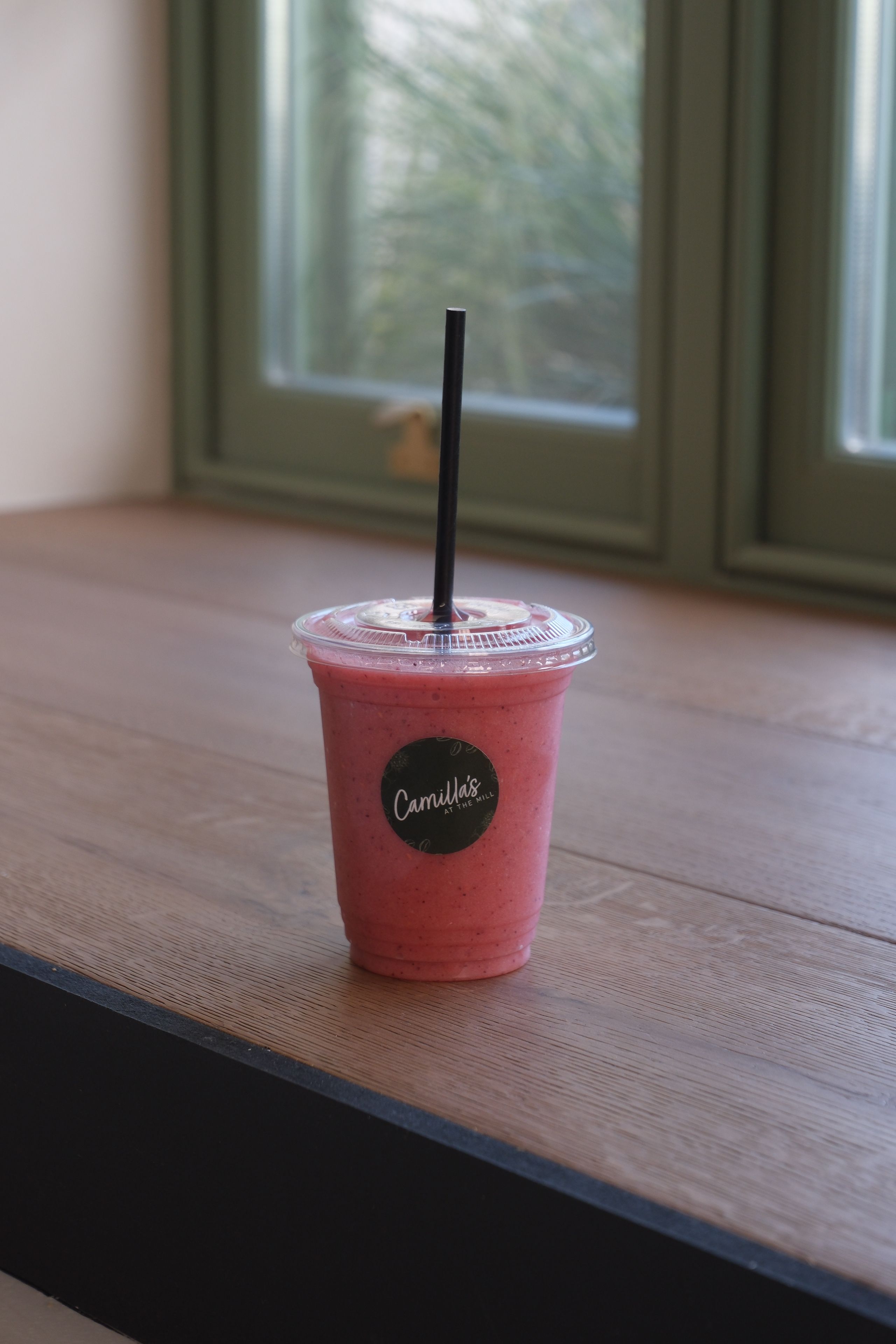 A raspberry smoothie in a glass