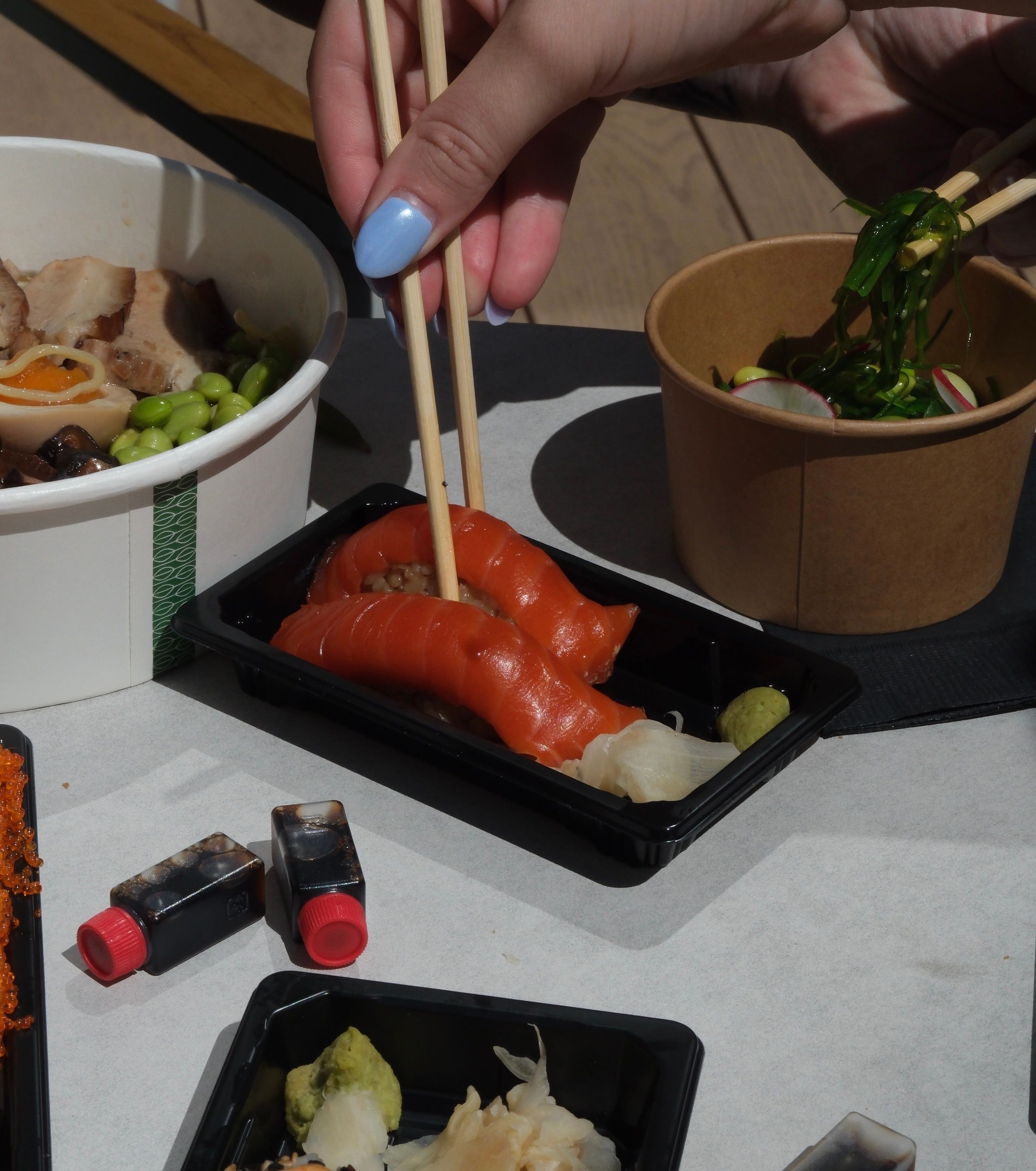 2 slices of raw fish served on top of vinegared rice