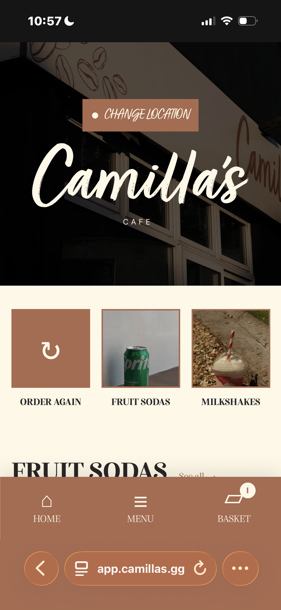 A mobile screen showing the Camilla's Cafe ordering app with menu categories like 'Fruit Sodas' (depicting a Sprite can) and 'Milkshakes'.