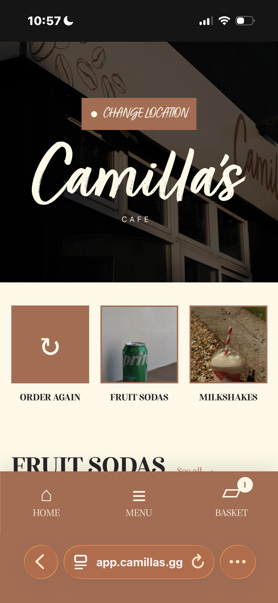 A mobile screen showing the Camilla's Cafe ordering app with menu categories like 'Fruit Sodas' (depicting a Sprite can) and 'Milkshakes'.