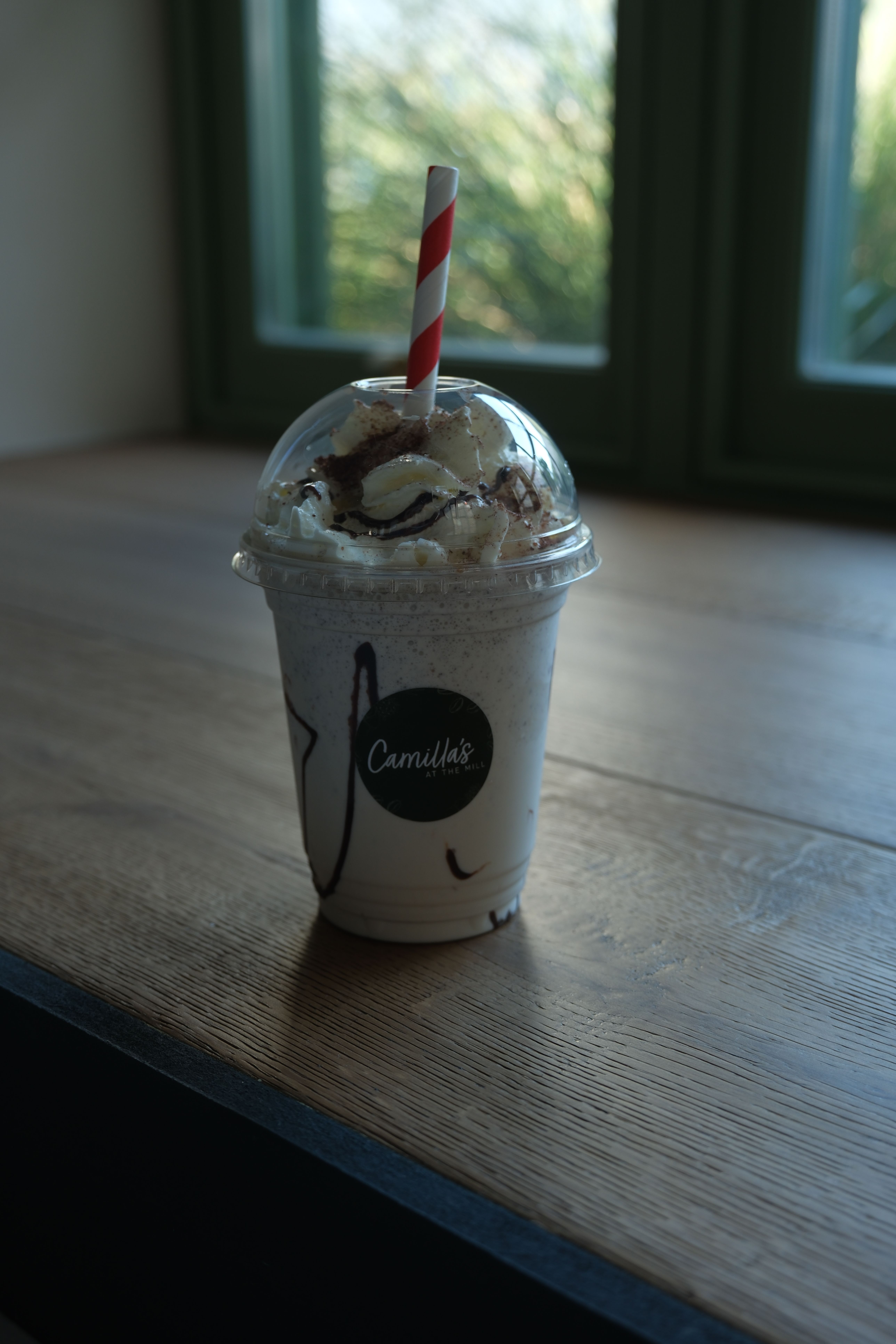 A cookies and cream milkshake topped with cream