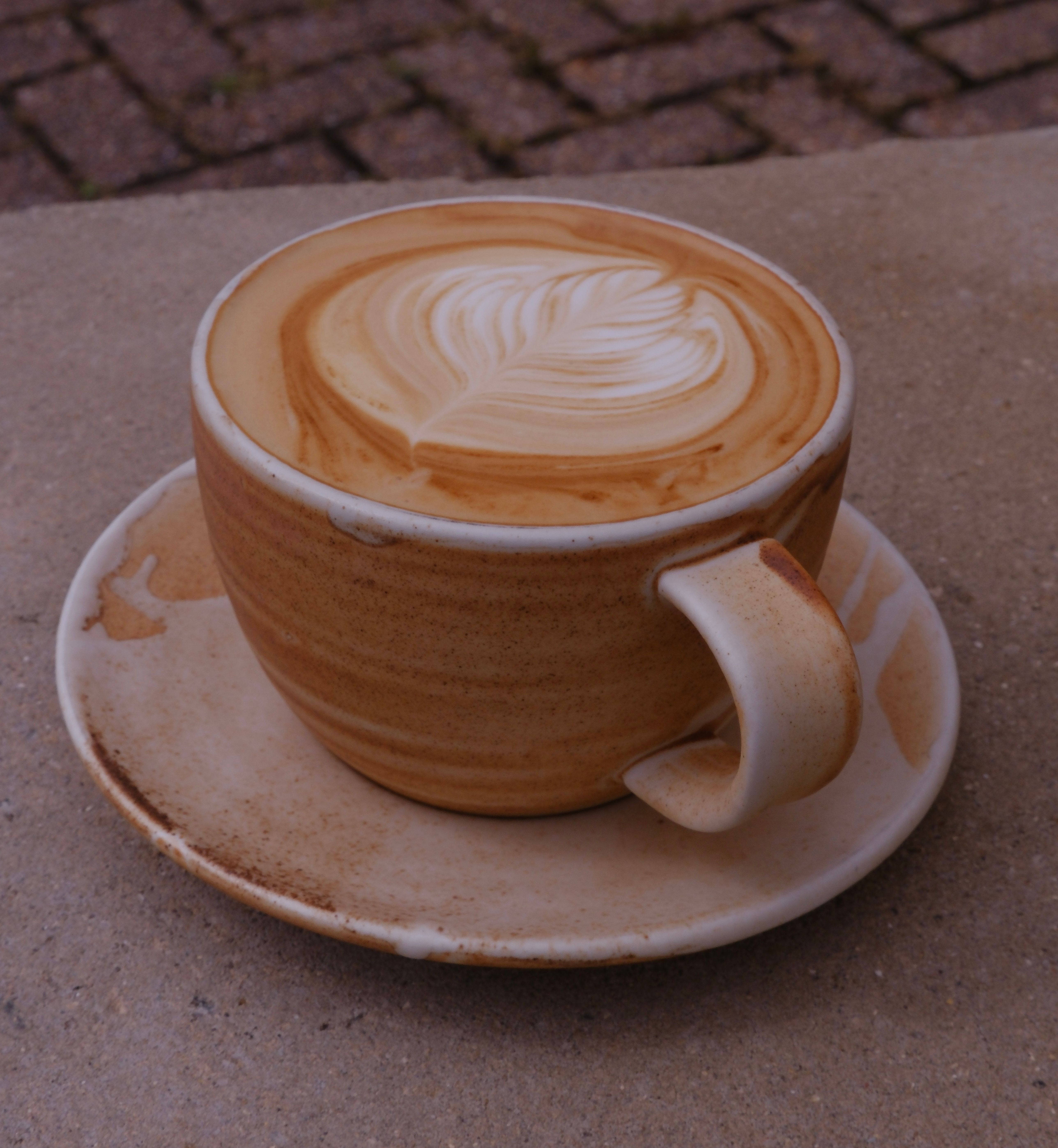 A flat white coffee in a cup