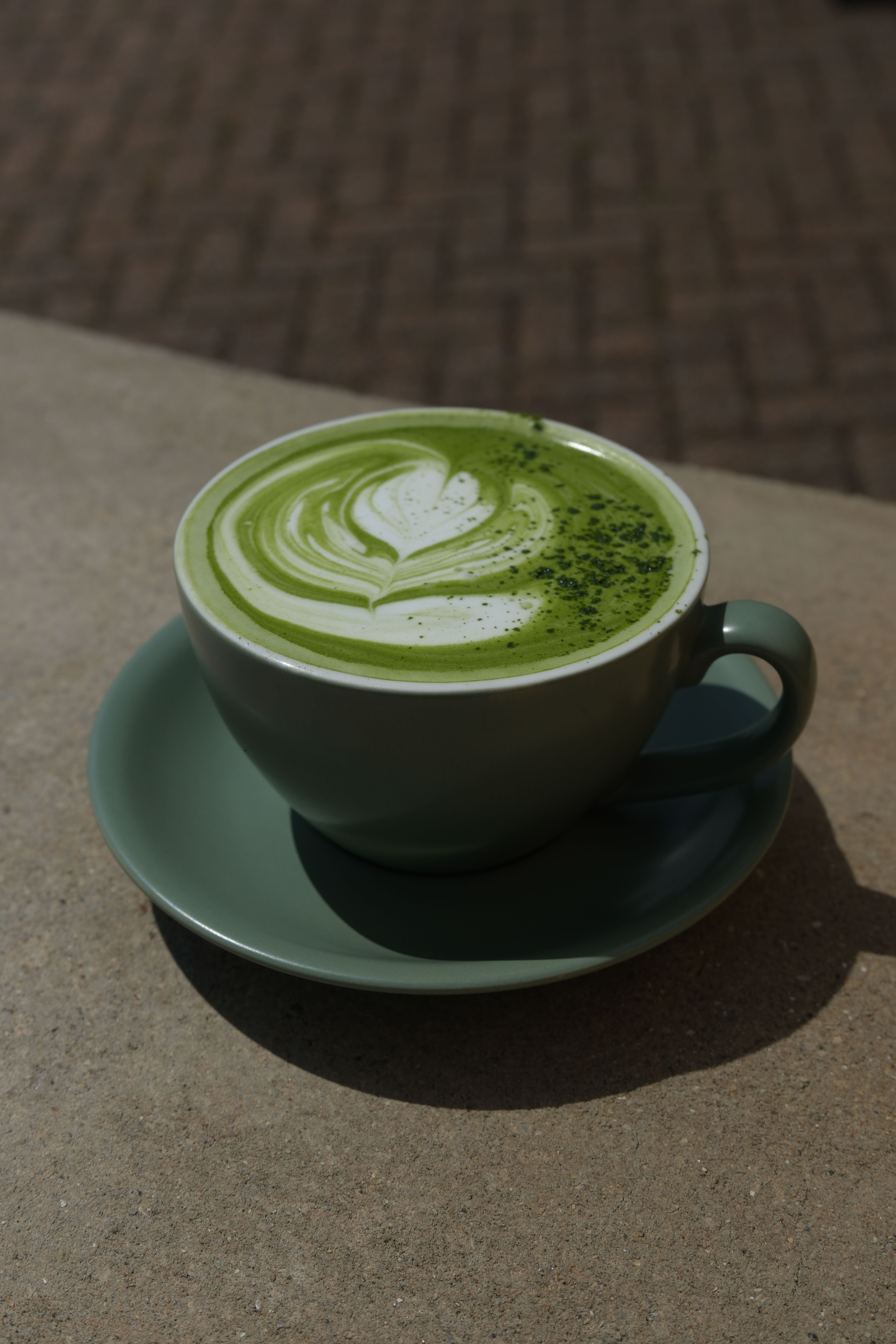 A green matcha latte in a glass