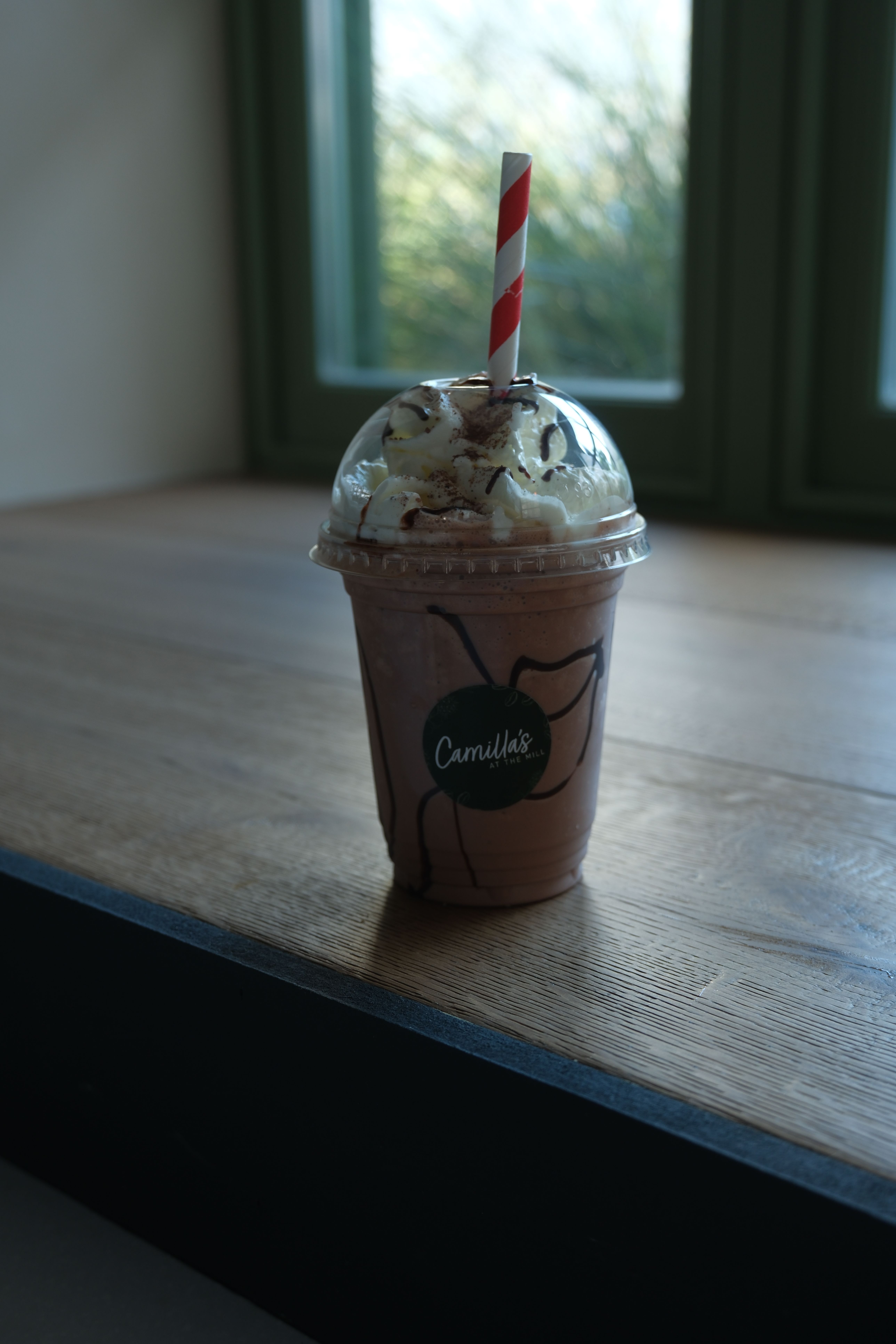 A double chocolate milkshake topped with cream