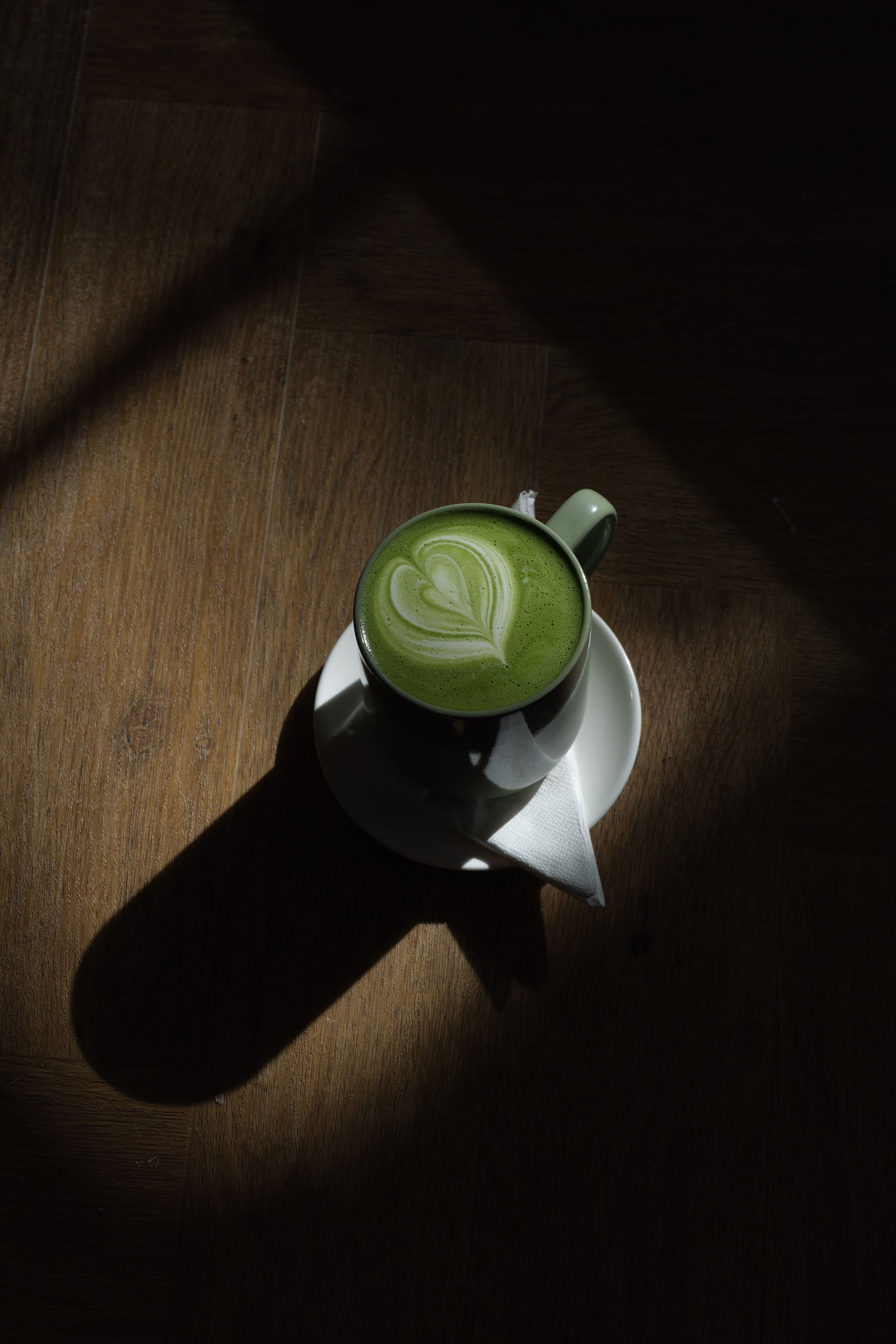 A green matcha latte in a glass