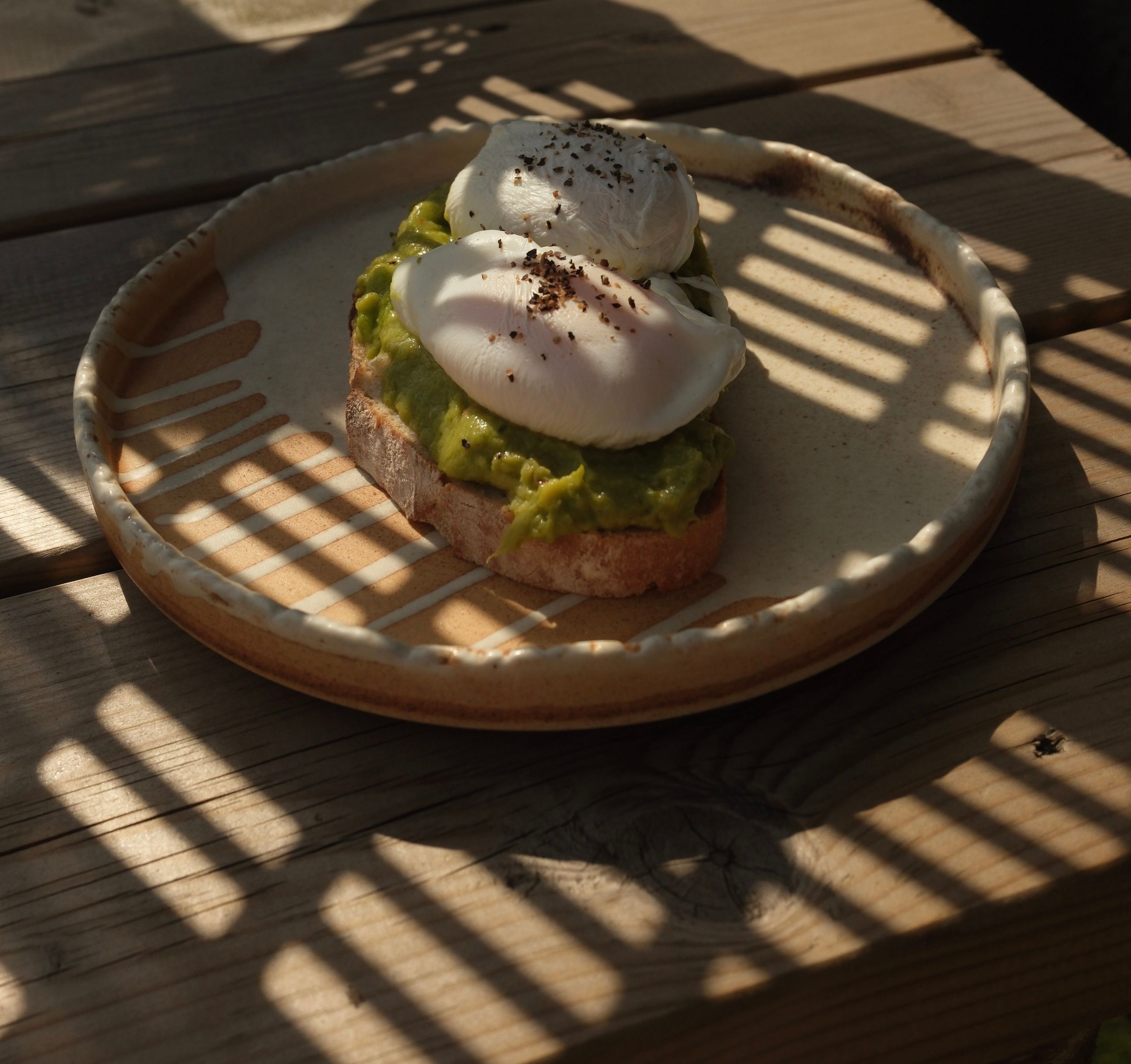 Smashed avocado and a poached egg on toasted sourdough