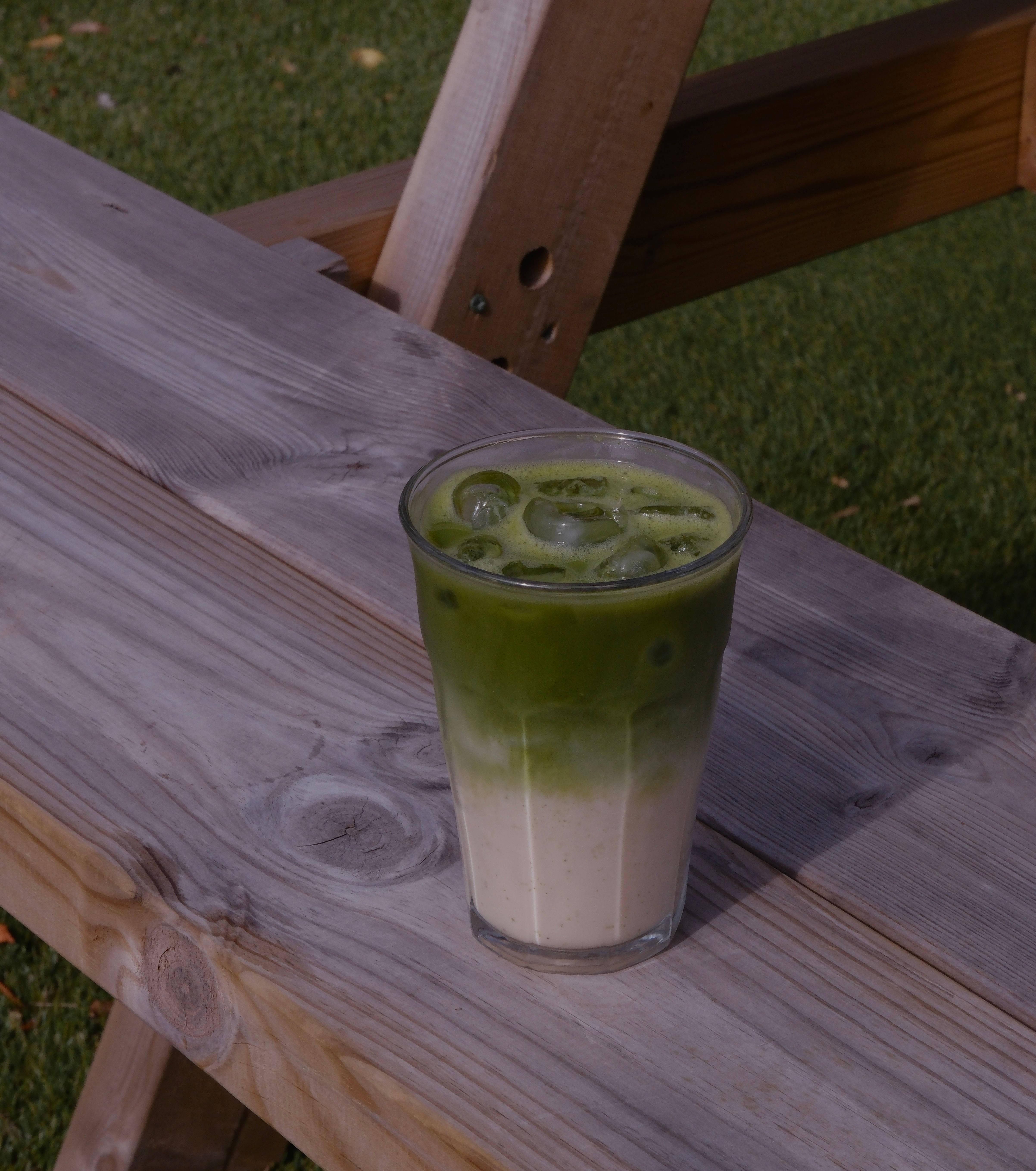 An iced green matcha latte in a tall glass