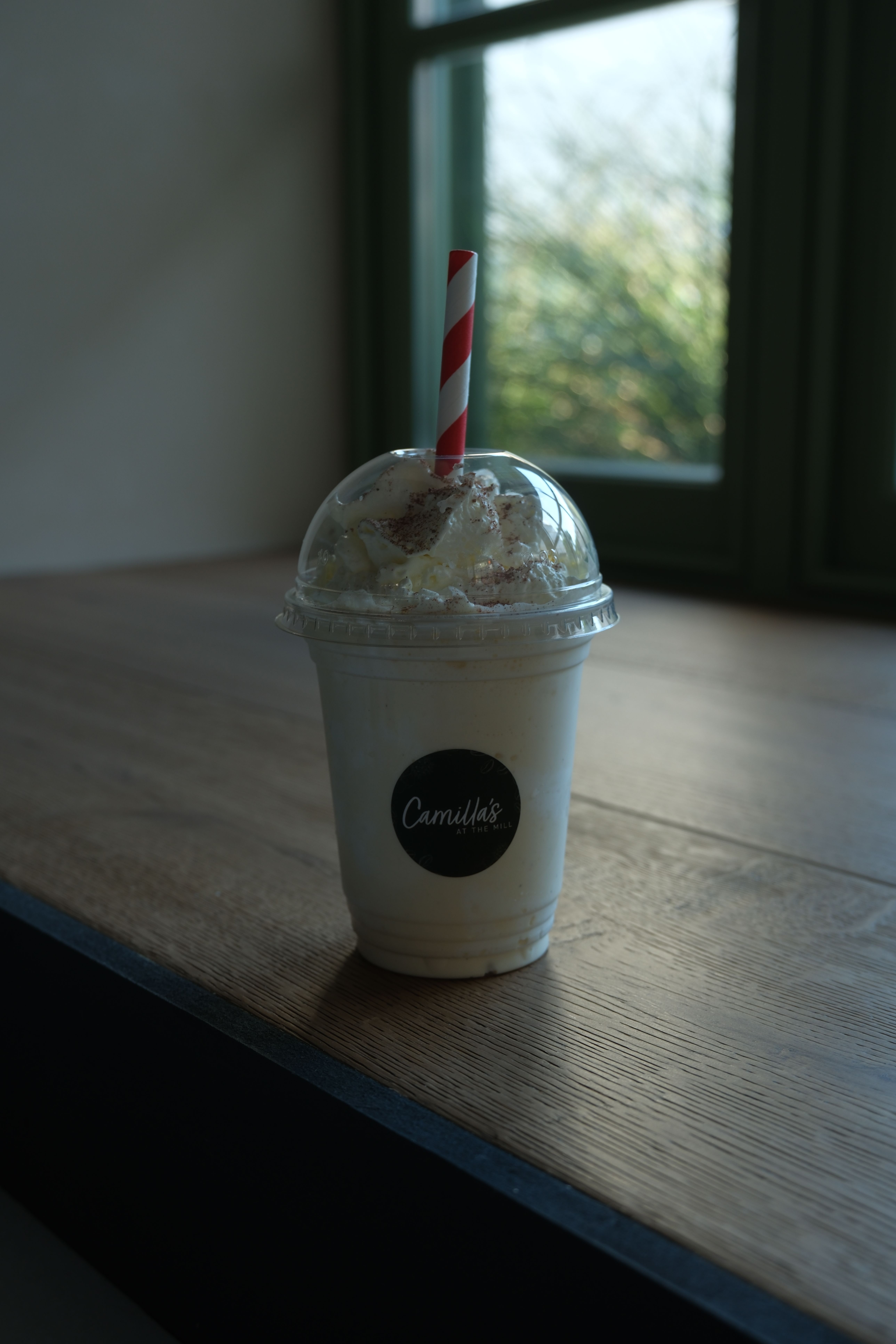 A vanilla milkshake topped with cream