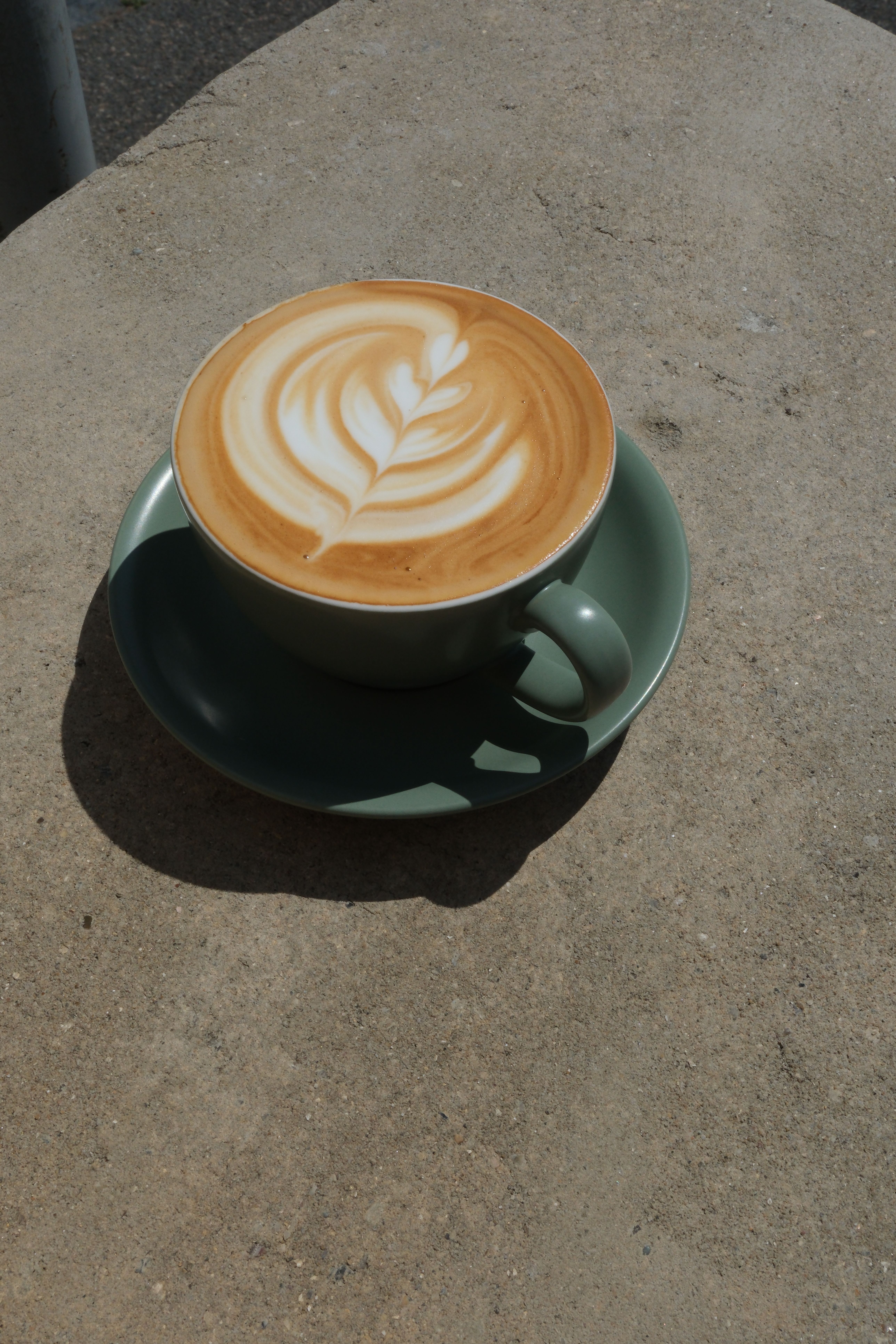 A latte coffee in a tall glass