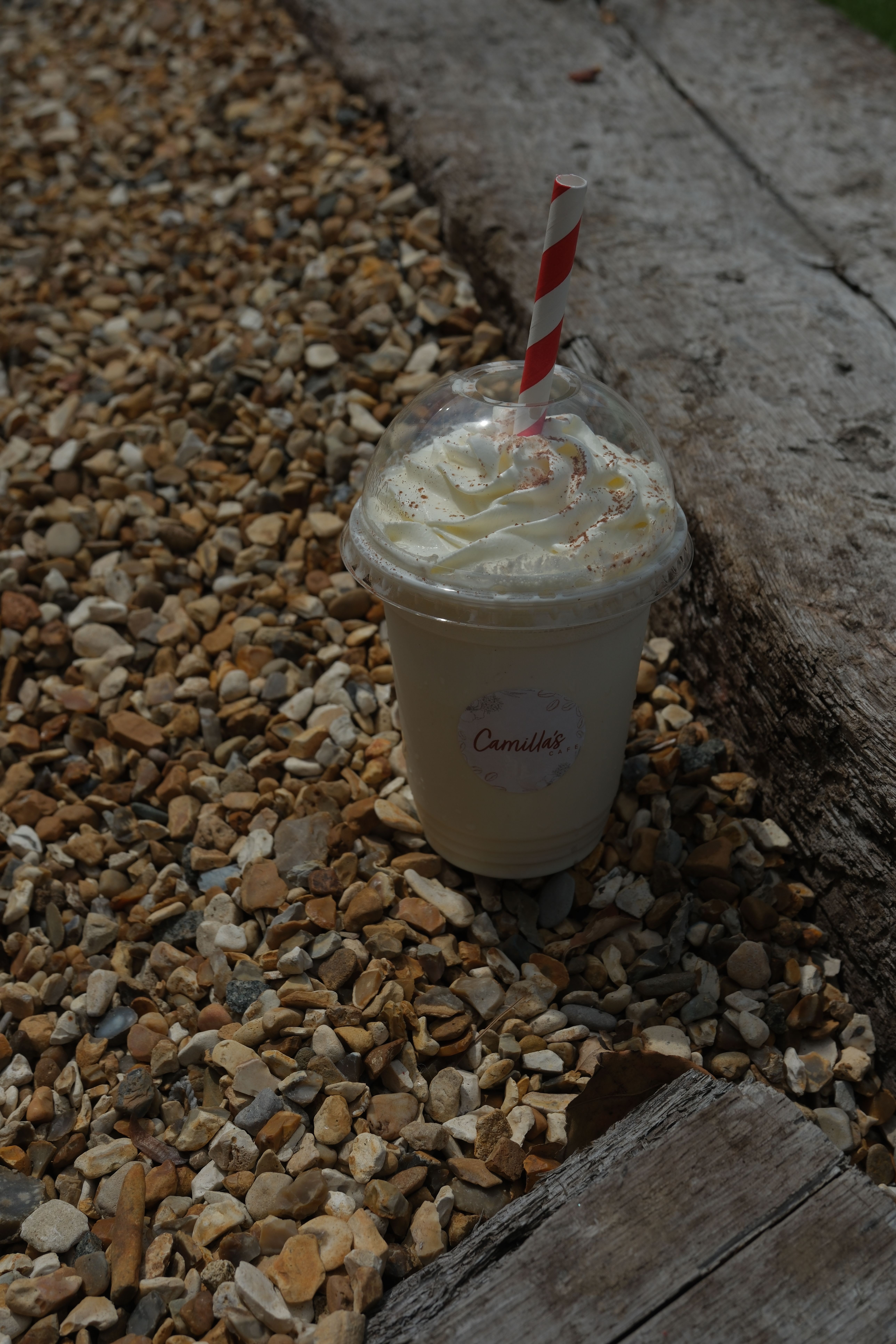 A vanilla milkshake topped with cream