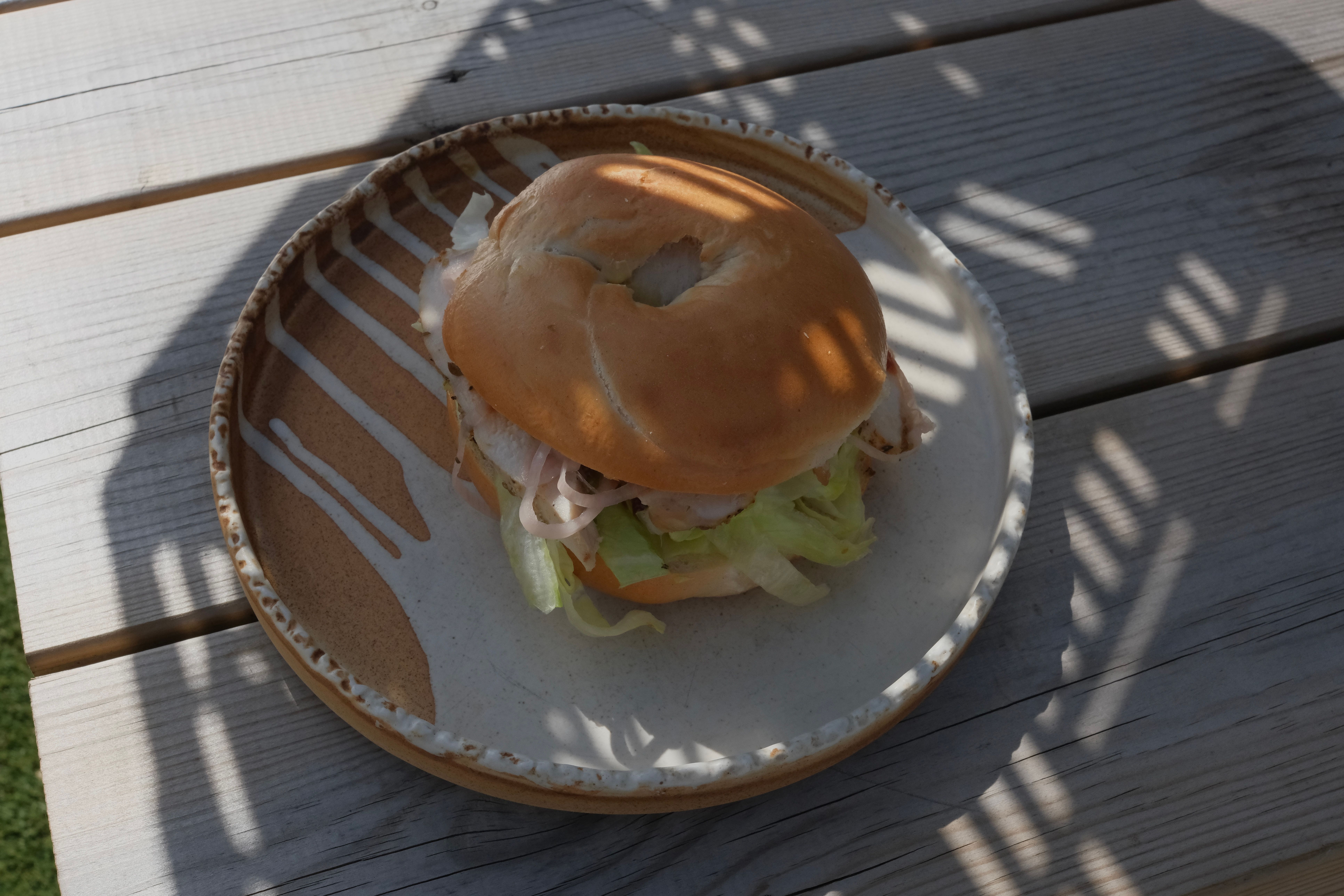 A grilled chicken sandwich with lettuce and tomato