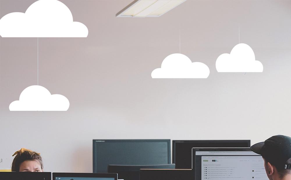 Illustration of office workers and computer screen with paper clouds hanging above them | Miracle Mill