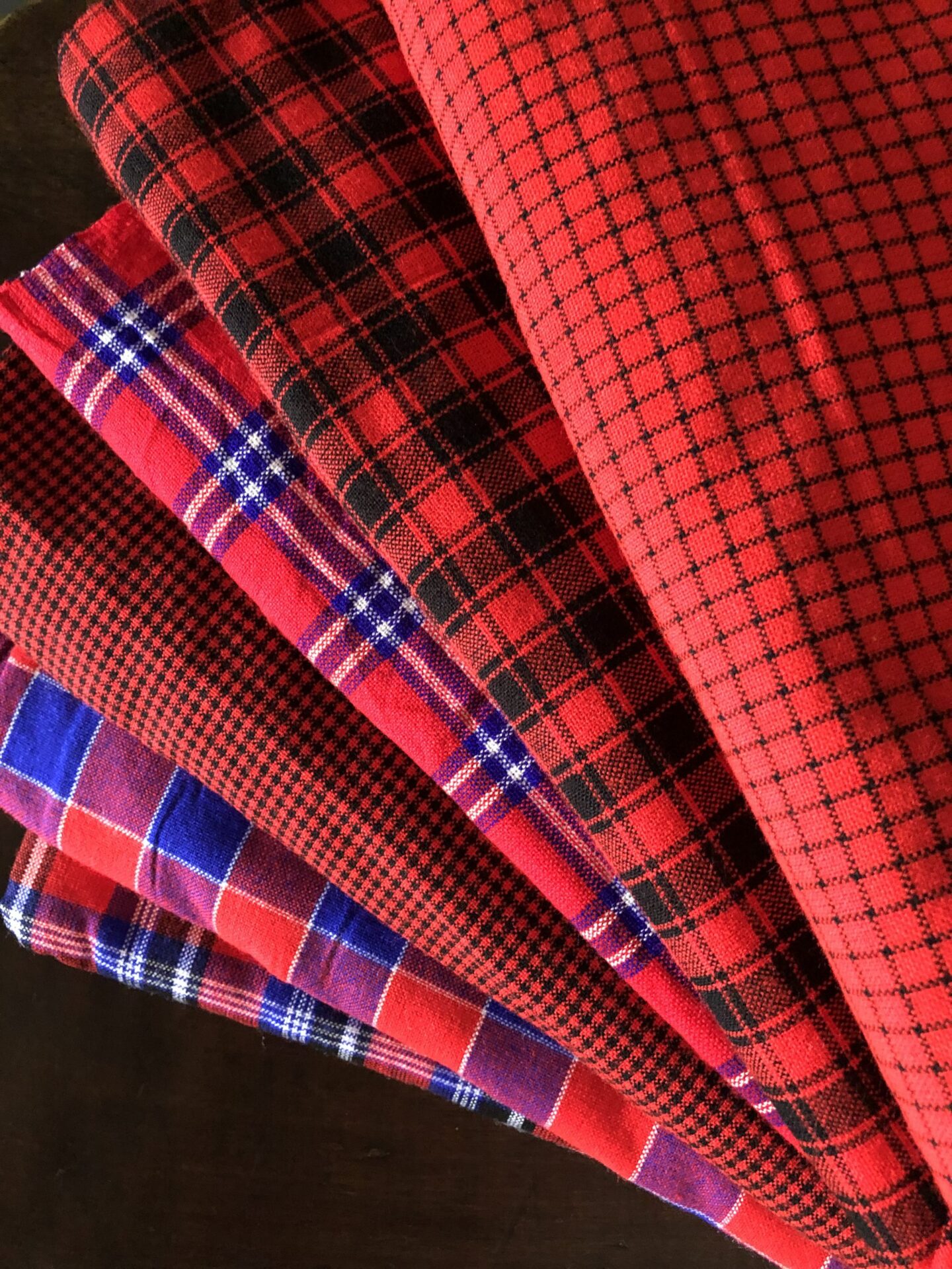 The Kenyan Maasai shuka is more than just a piece of cloth – it is a living symbol of heritage, pride, and identity. Worn for centuries by the Maasai people of East Africa, this shuka is instantly recognizable with its bold colors, distinctive checkered or striped patterns, and durable weave. Each piece tells a story of resilience and tradition, making it one of the most iconic African textiles. Crafted from high-quality cotton or acrylic blend, the Maasai shuka is lightweight yet warm, perfect for use in both hot and cool climates. It is highly versatile: wear it draped as traditional clothing, use it as a blanket or picnic mat, throw it over your couch for an eye-catching African décor piece, or gift it to someone who appreciates authentic handmade products from Kenya. Bring home a piece of Africa with this authentic Kenyan Maasai shuka . Bold, practical, and deeply cultural, it is a timeless item that connects you to one of the most celebrated communities in Africa.