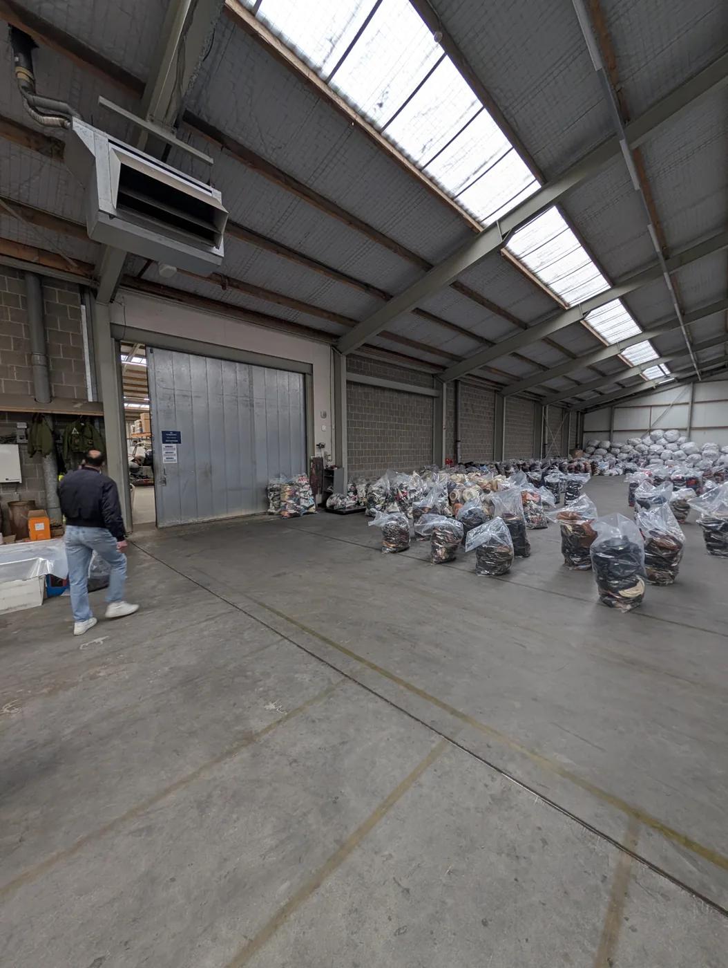 Sorted secondhand clothing bales on the Excellent Vintage warehouse floor in Bovenkarspel, ready to choose by brand and grade