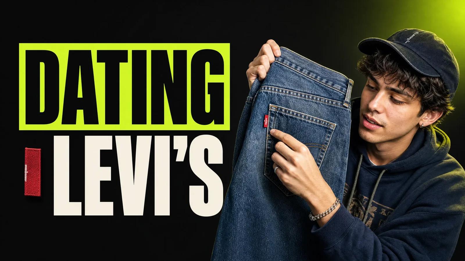 Young reseller inspecting the red tab on the back pocket of a vintage pair of Levi's jeans