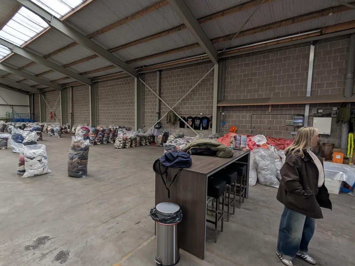 Sorting area where secondhand clothing is assessed for quality at Excellent Vintage