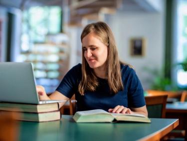 Visually impaired woman sitting in front of laptop