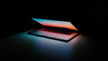 Photo of laptop in dark room, by Ales Nesetril on Unsplash
