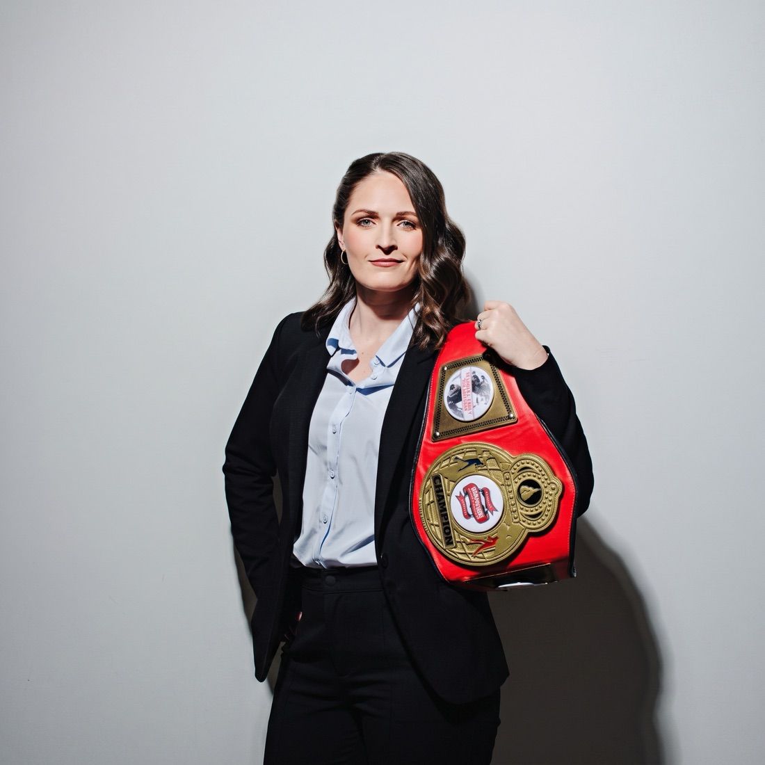 Kaitlyn Clark holding her championship belt