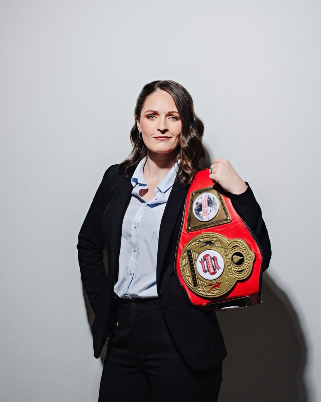 Kaitlyn Clark holding her championship belt