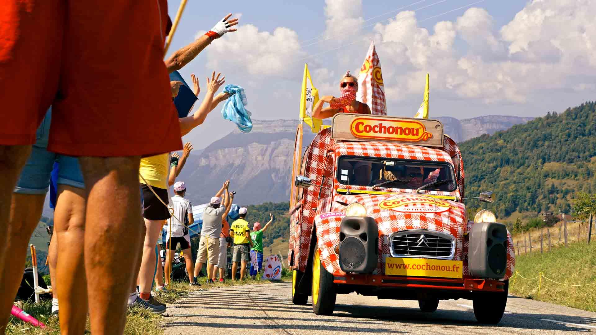 Spectators and advertising caravan on the Tour de France.