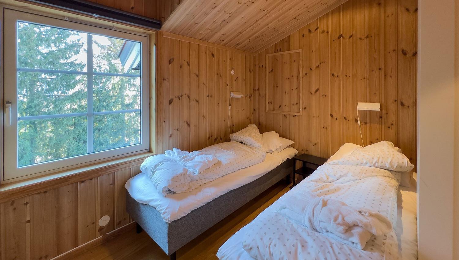 A room with two beds and a window.