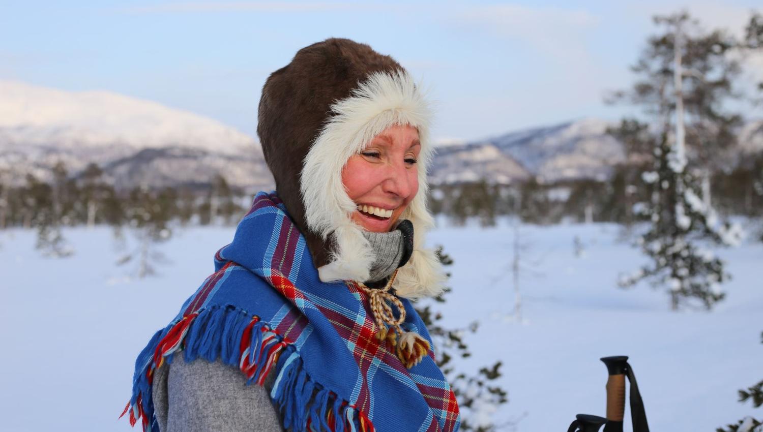 smiling woman outside in winter landscape