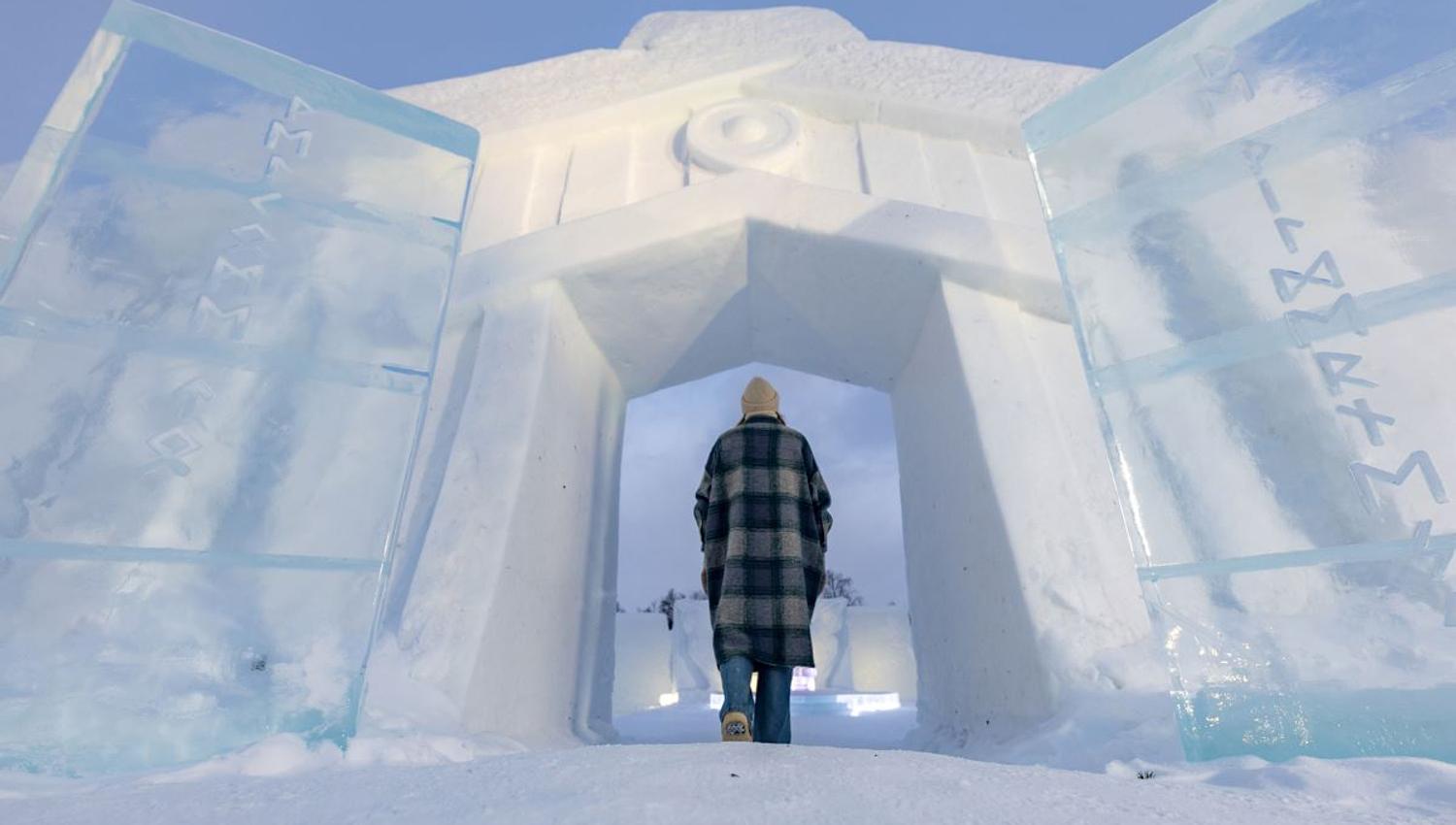 A guest poses in the doorframe of the Ice Domes.