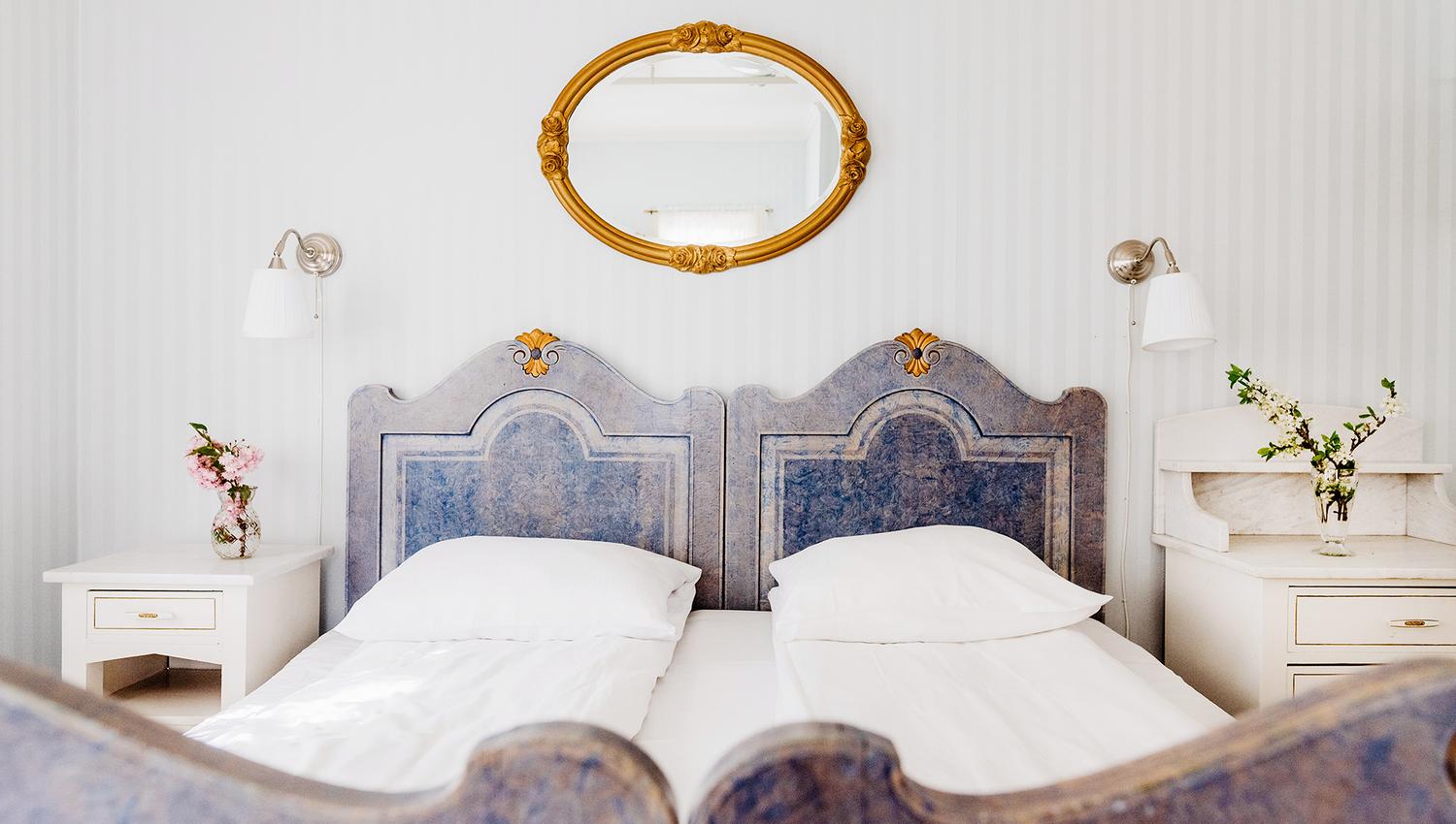 Unique double room with historic furniture and charming details at Utne Hotel.