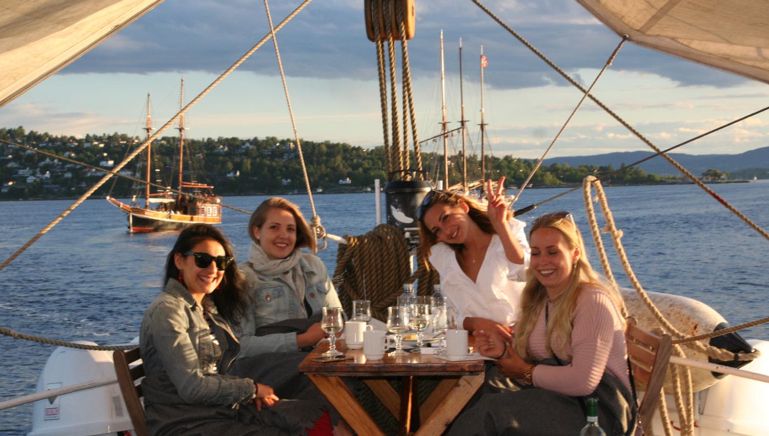 Four girls enjoying a drink on board.