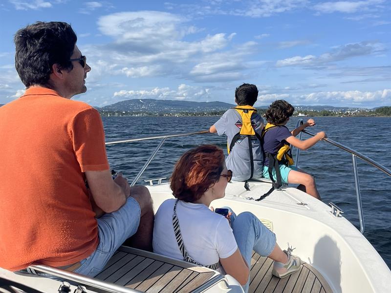 Family on front deck of boat, sea view