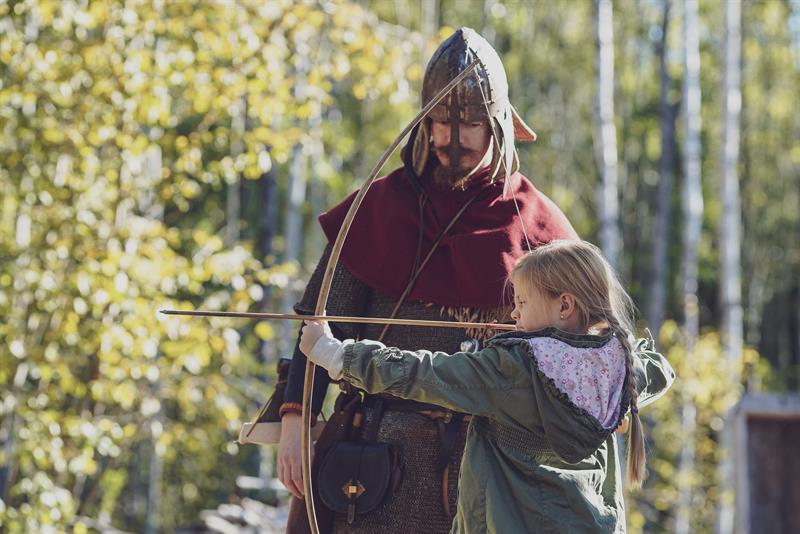 Girl shooting with a bow and arrow