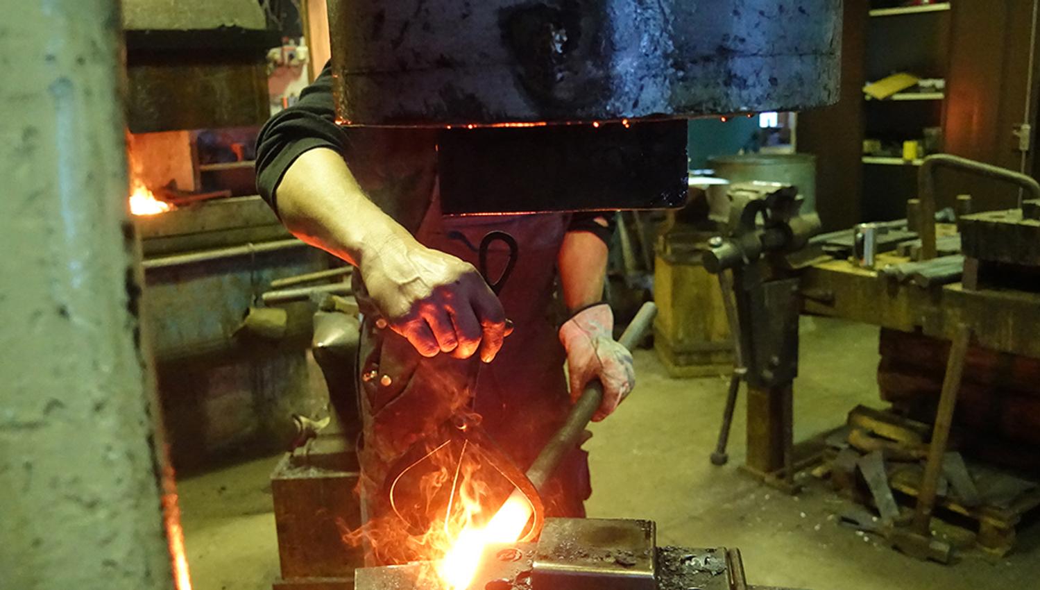 Blacksmithing at Hardanger Maritime Center with metal being heated in a forge.
