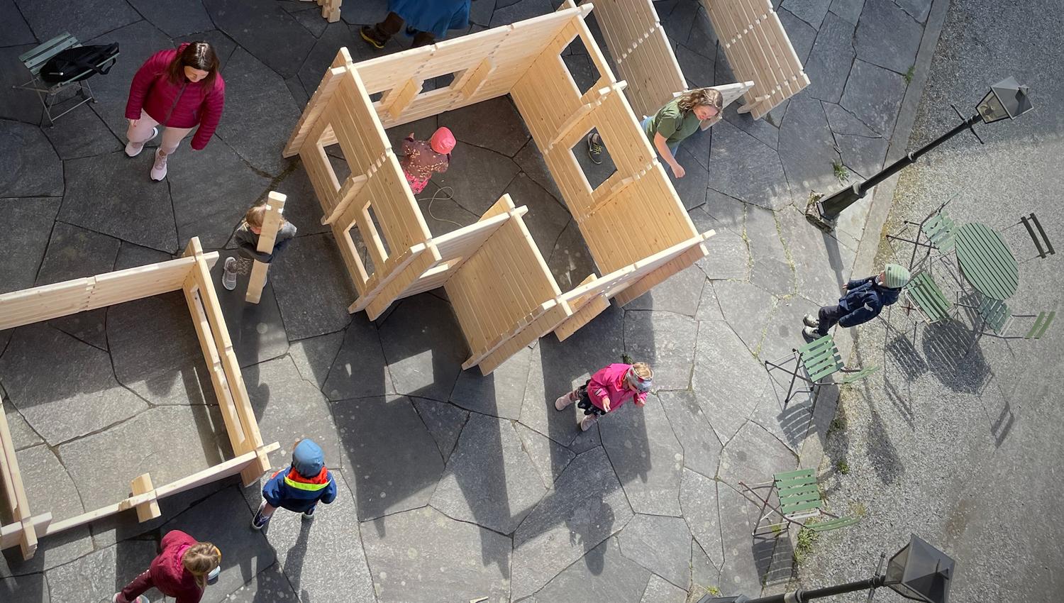Children playing with wooden house building sets at Hardanger Maritime Center.