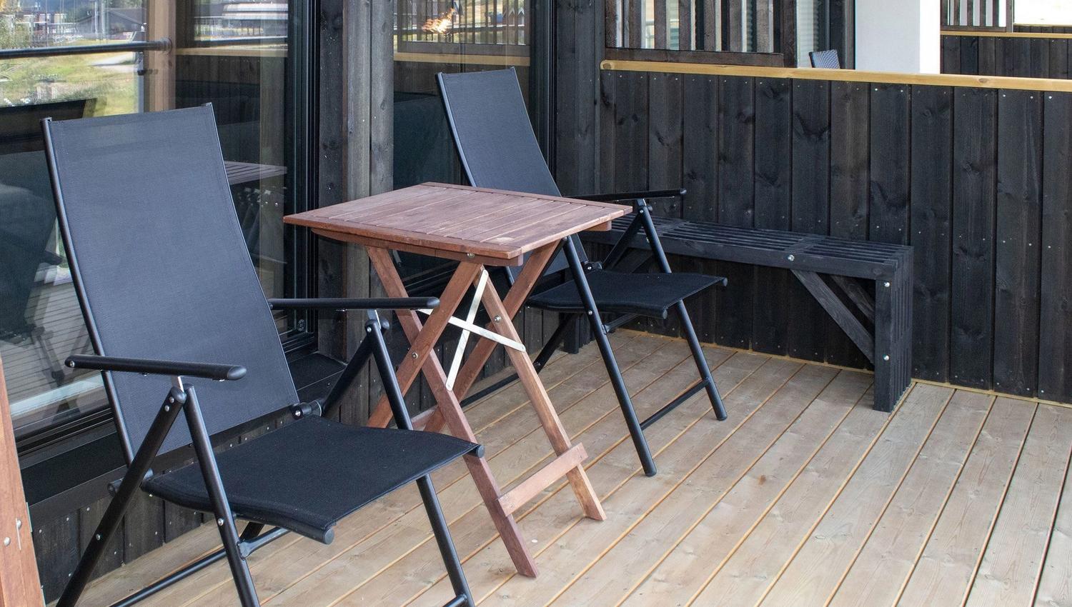 A table and chairs on a terrace.
