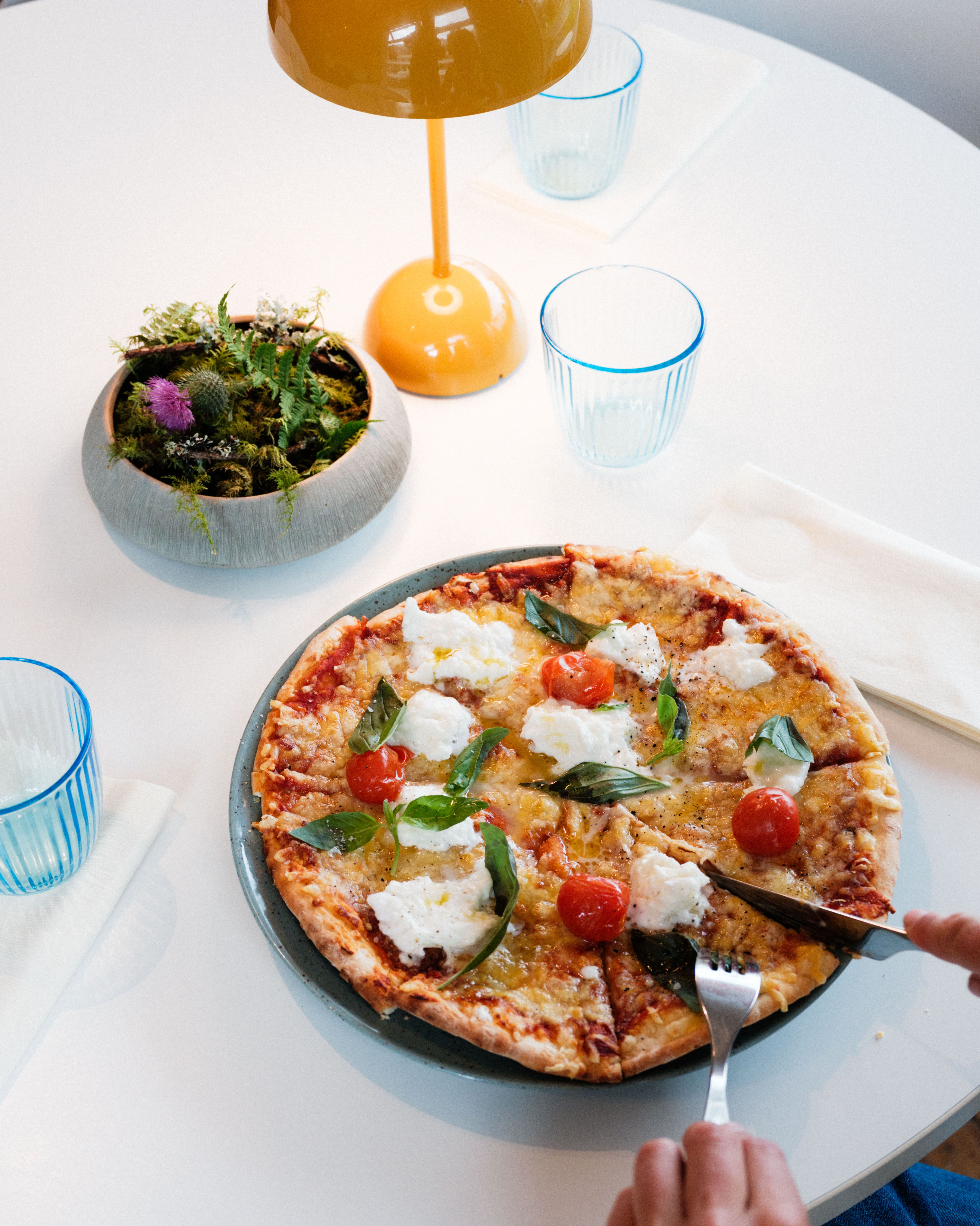 Steinomnsbakt pizza med fersk basilikum, cherrytomat og kremost på Gløyp Spiseri.