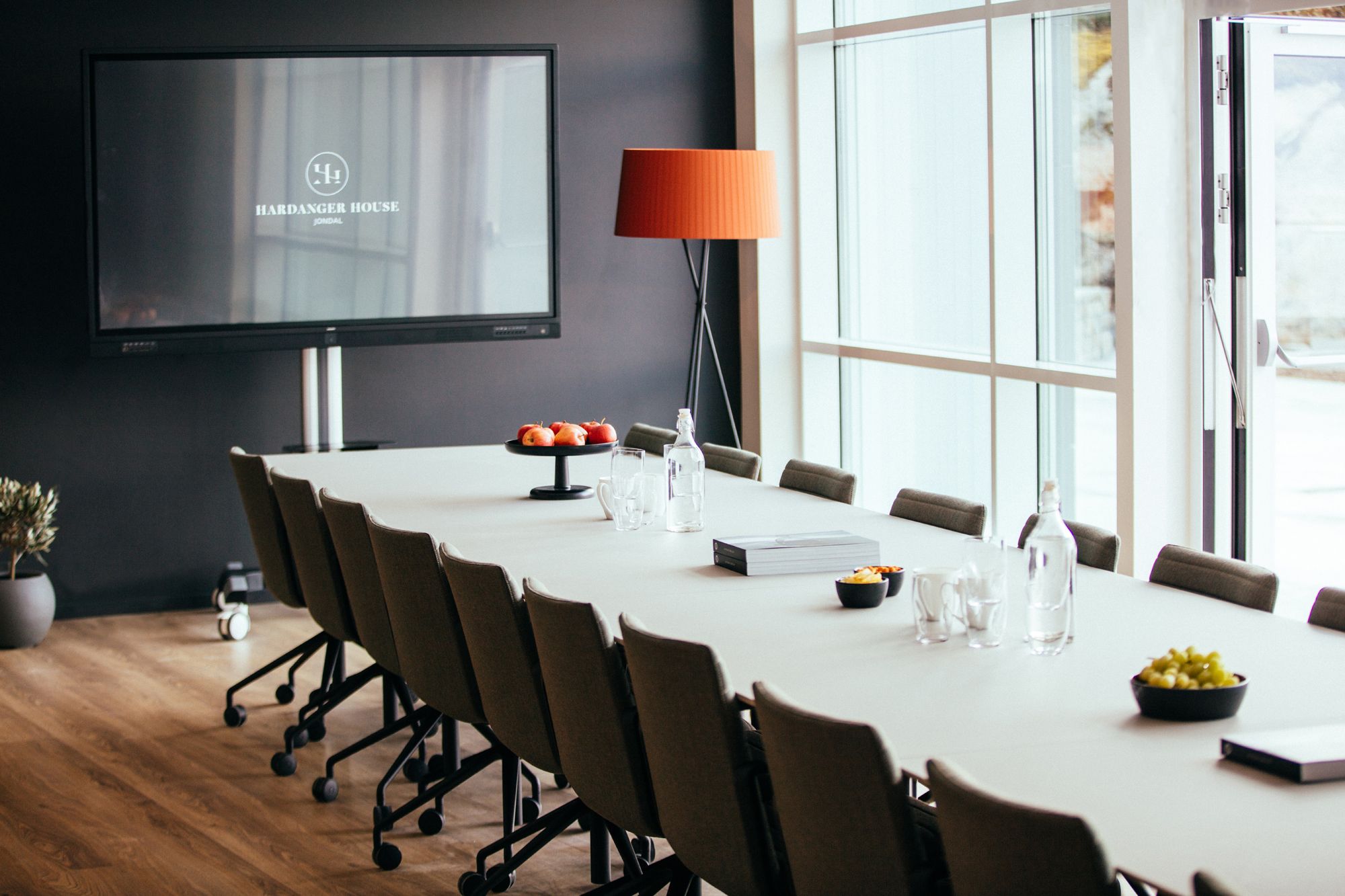 Conference room at Hardanger House with a long table and screen for meetings.